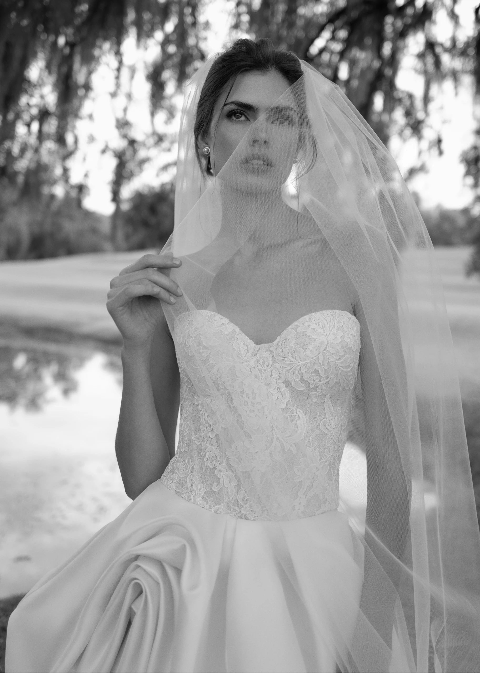 The Wentworth gown is a strapless drop waist corset bodice of French Alençon and Chantilly laces with an Italian Kalika ballgown skirt featuring sculptural origami-style pick-ups and asymmetric waterfall draping.