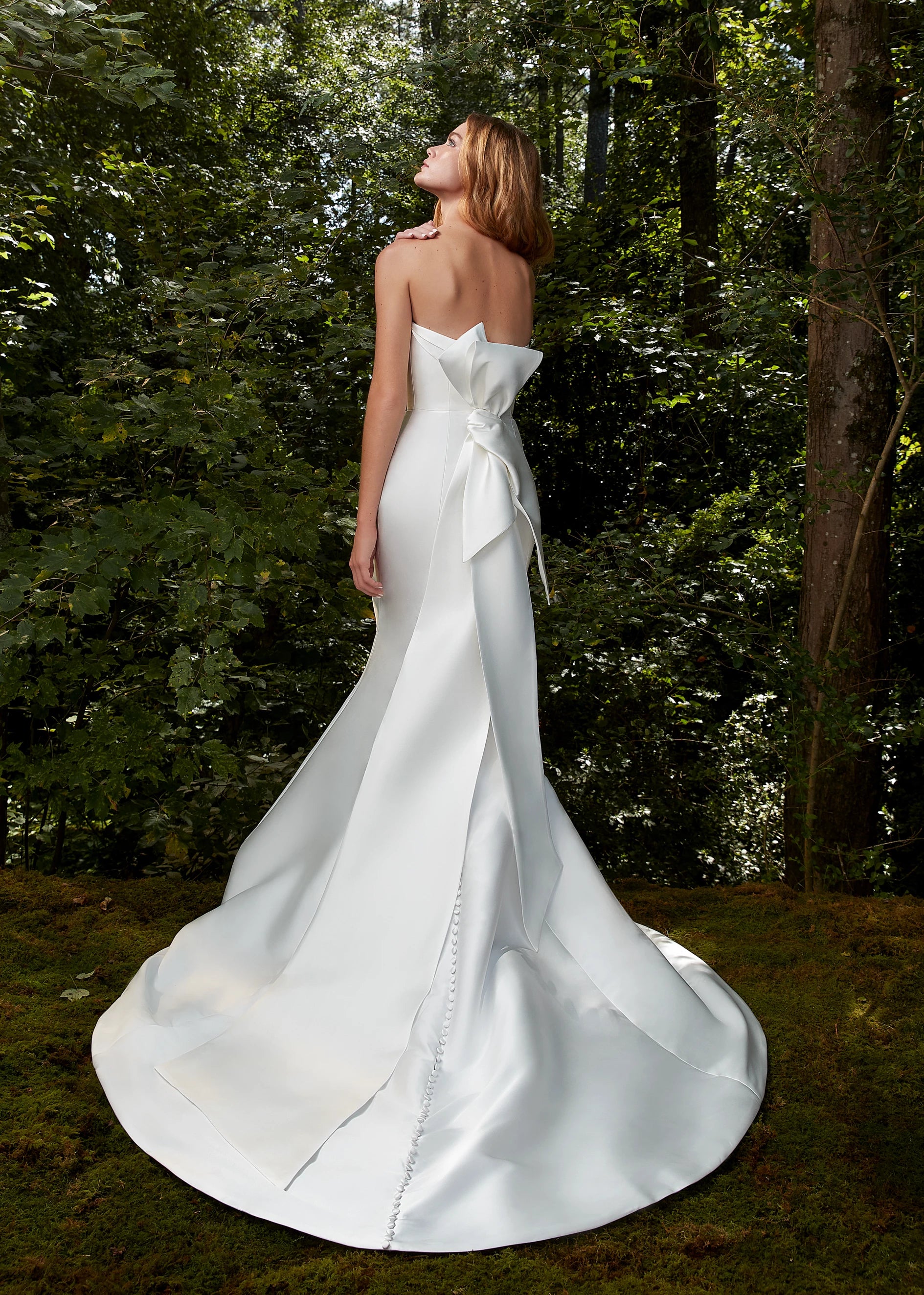 The Bisous Bow by Anne Barge is an origami style bow with sashes in Mikado Scuba in Silk White.