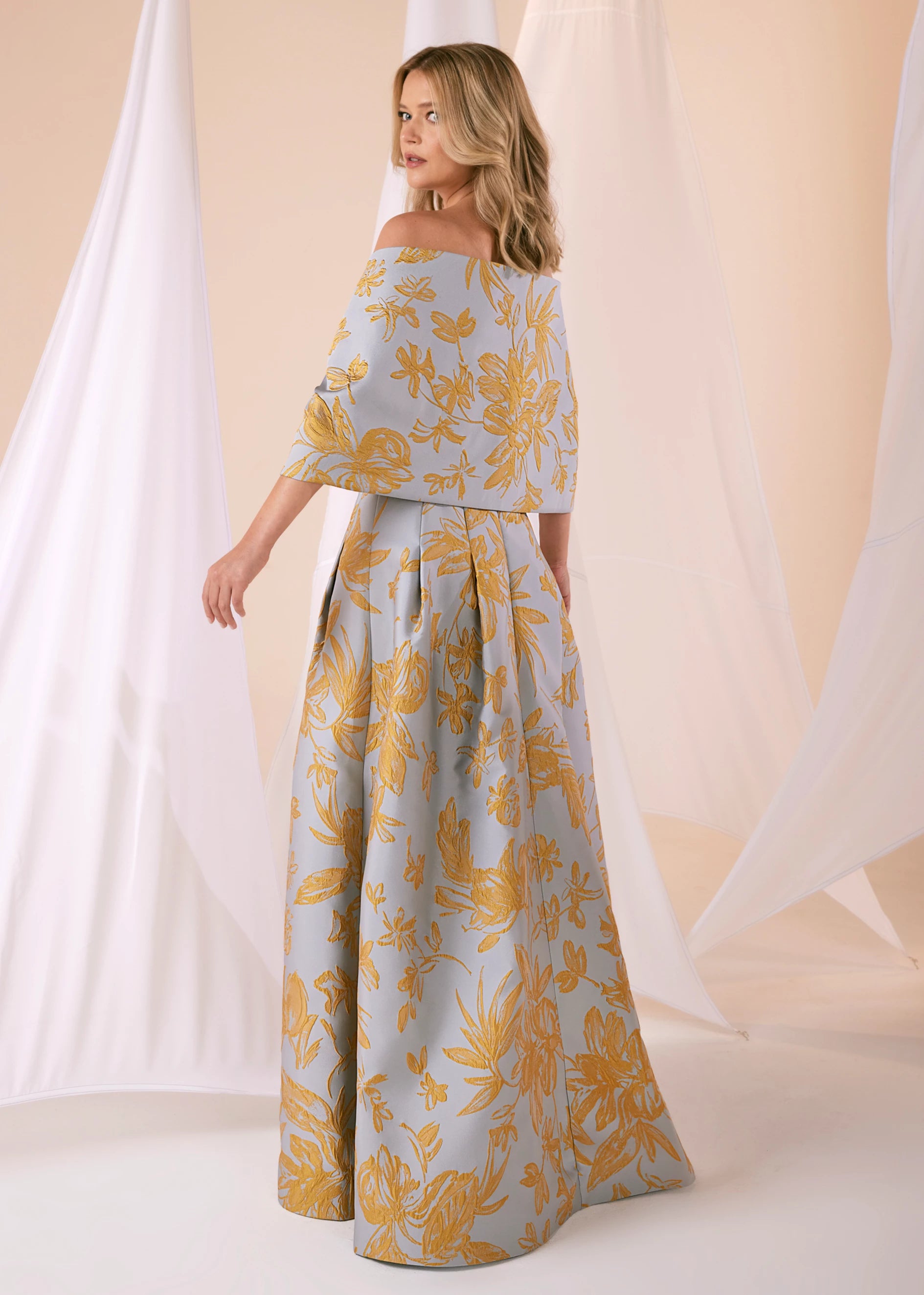 The Bryn Wrap from Black Label by Anne Barge is an elastic wrap in Floating Floral Jacquard meant to be worn over or off-the-shoulder