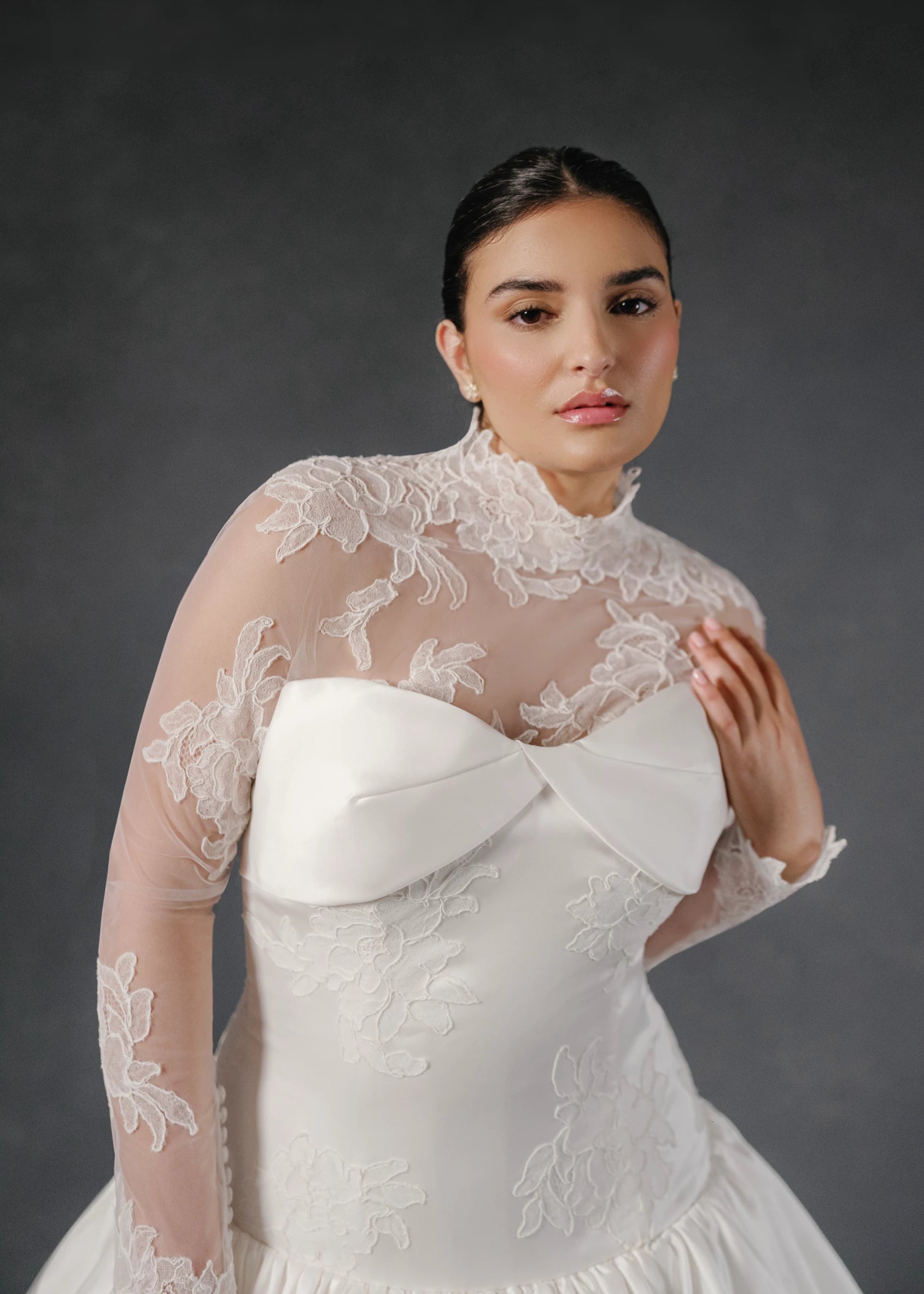 The Noblesse gown is a contour strapless drop waist ball gown of Silk Satin Organza with a draped neckline, delicate French Alençon lace appliqués, and a gathered skirt finished with buttons to the hem in Silk White.