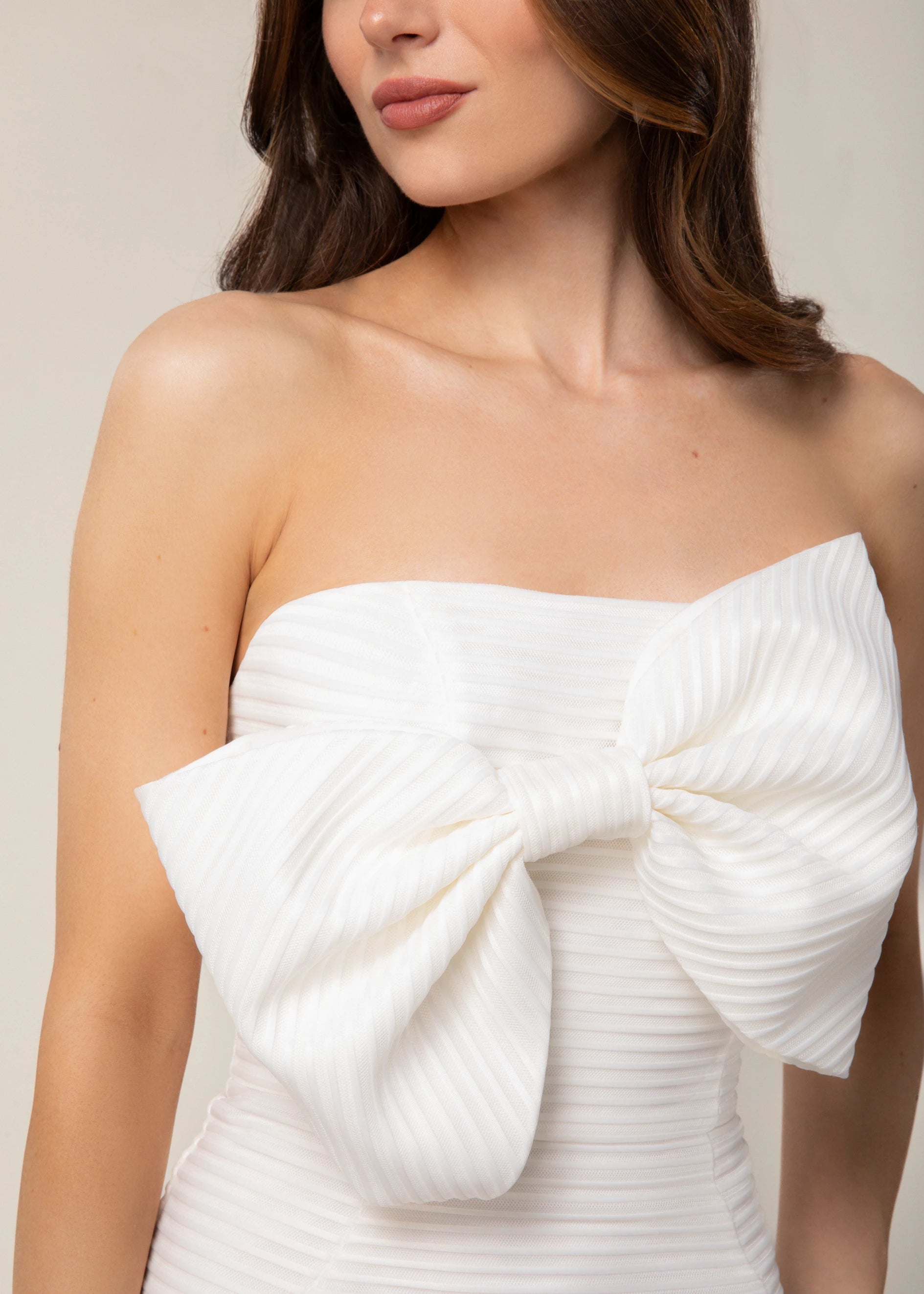 Anne Barge “Stand By Me” little white dress - Straight across neckline midi length dress of raised stripe knit jacquard with an angular ruffle at the hem and dramatic bow at bust in Silk White.