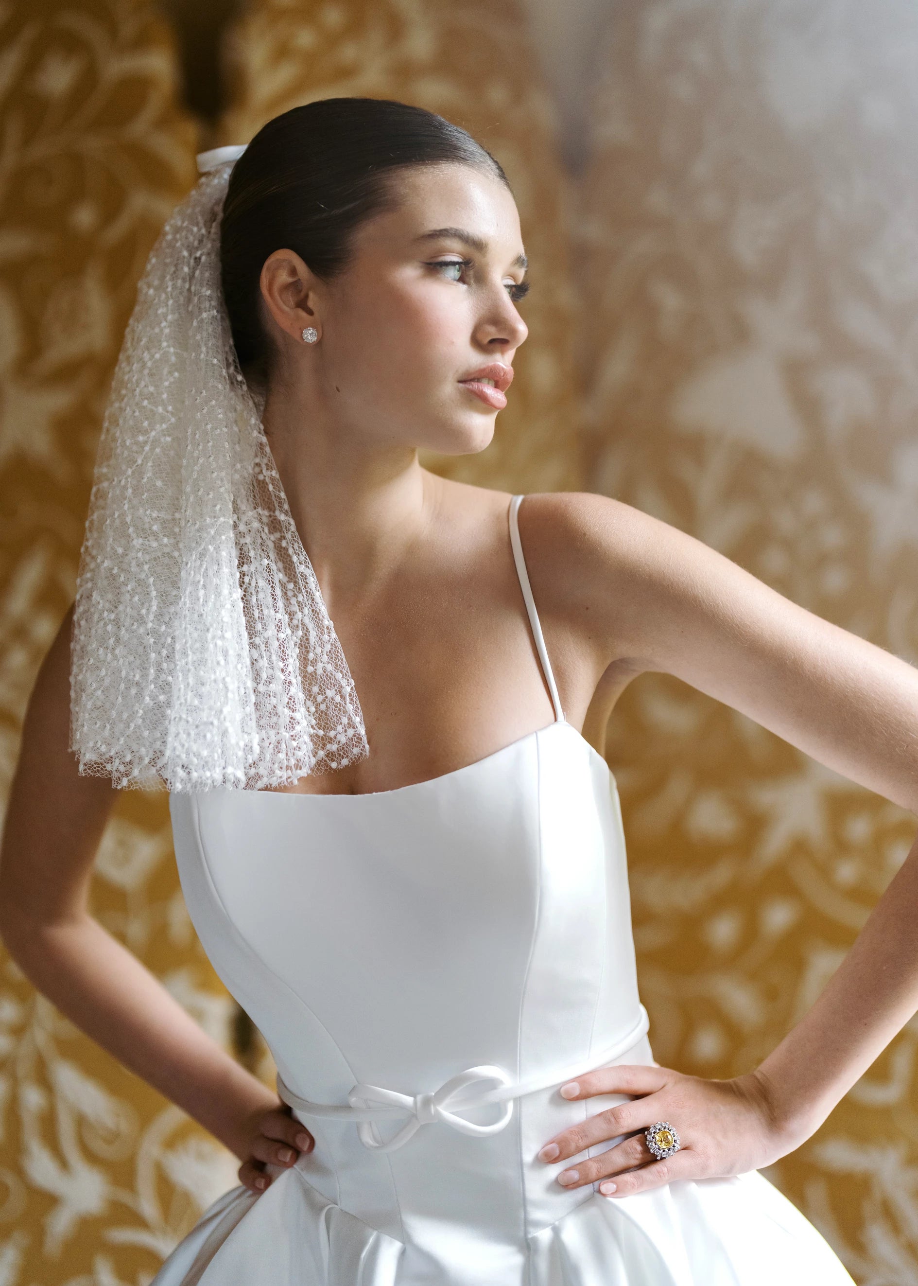 The Anne Barge Monde Belt is an Italian Satin thin belt with knotted bow at center in Silk White.
