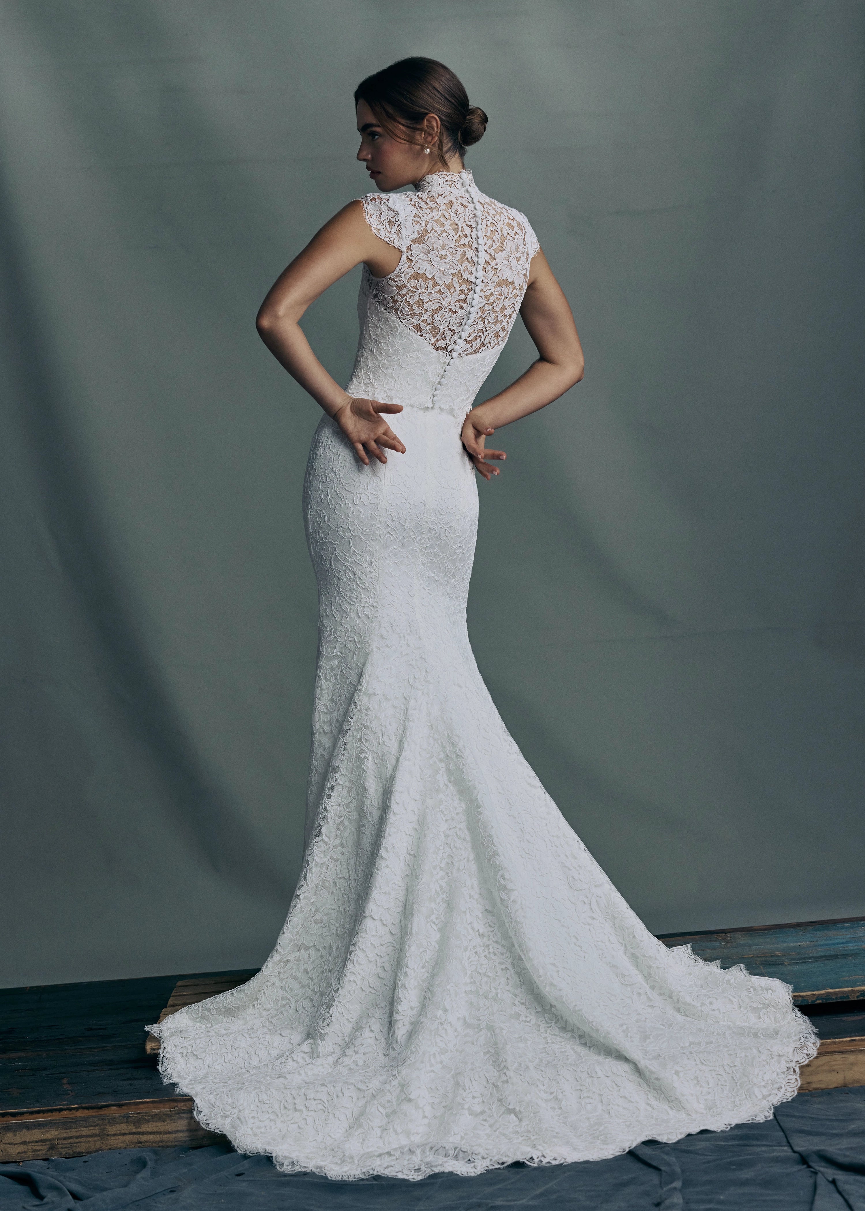 The back of the Anouk gown paired with the Anouk Top, a mockneck cap sleeve topper of Corded Scrolling Floral Lace. 