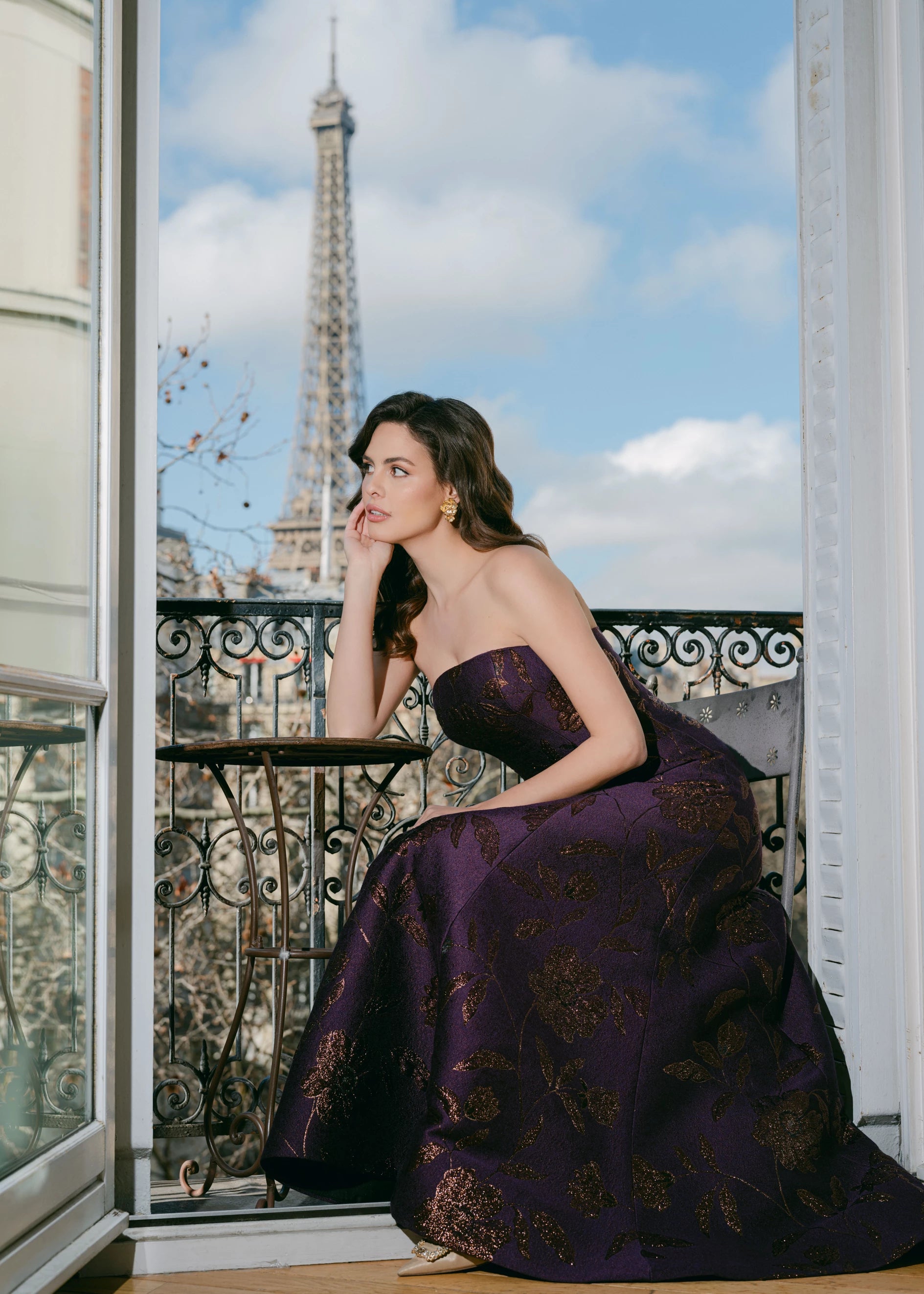 The L'Opera evening gown from Black Label by Anne Barge is an arched strapless modified A-line gown of Metallic Floral Brocade.