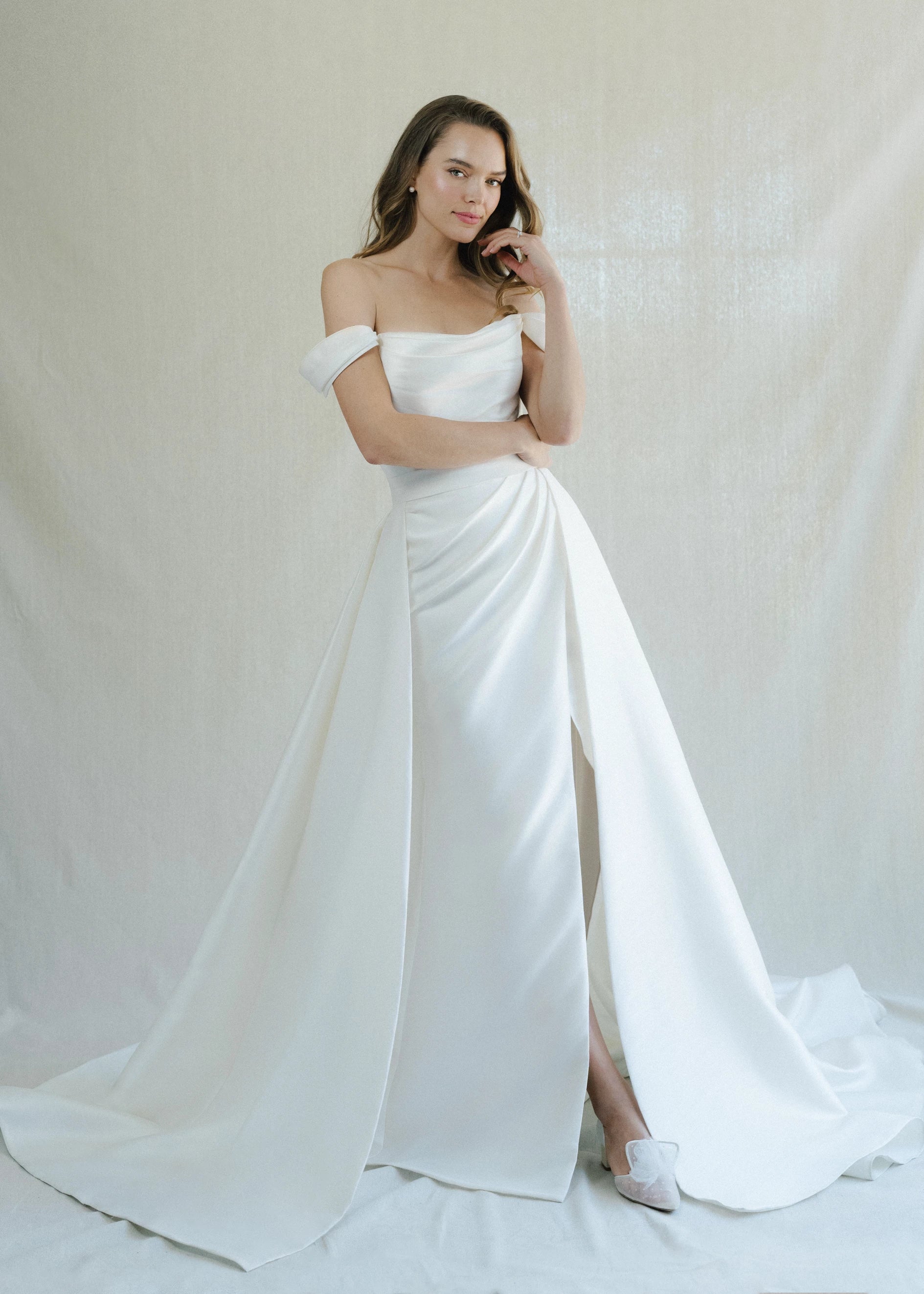 The Blue Willow Tucker Overskirt is a dramatic pleated overskirt of Soft Mikado in Pearl and Bright White.