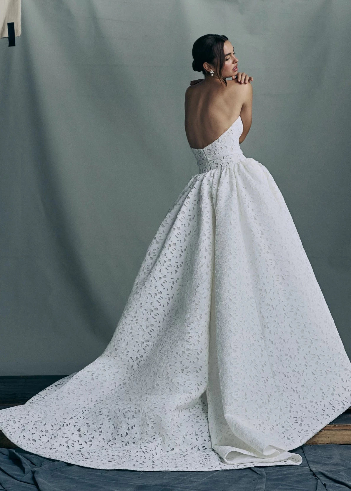 Back view of the Charlene gown by Anne Barge, an arched strapless gown in Embroidered Rose Laser Cut Satin with slightly dropped waist and gathered ballgown skirt in Silk White.