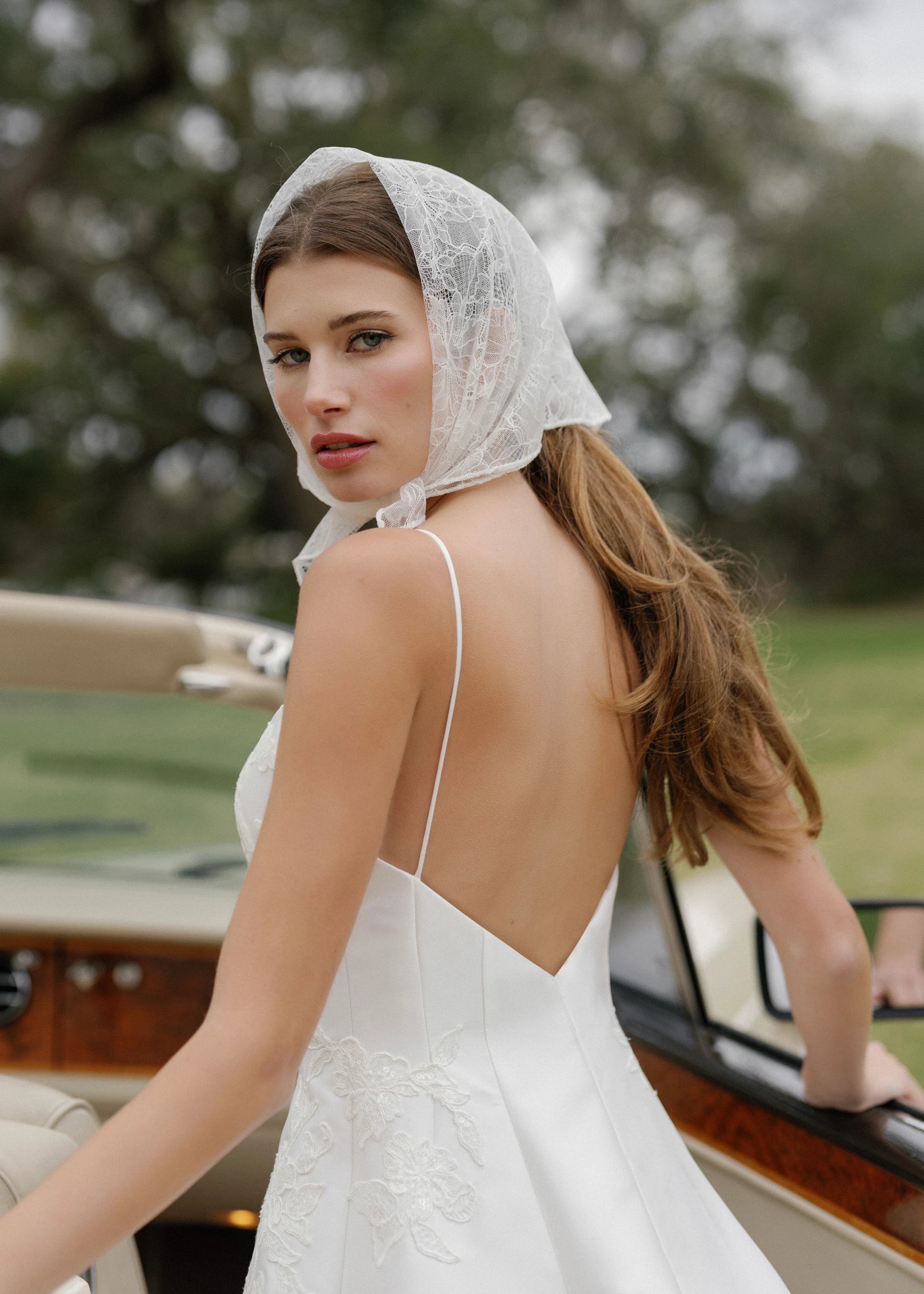The Charlie gown is a scoopneck spaghetti strap A-line gown of Soft Mikado with Sequined Corded Floral Lattice appliqués in Pearl.