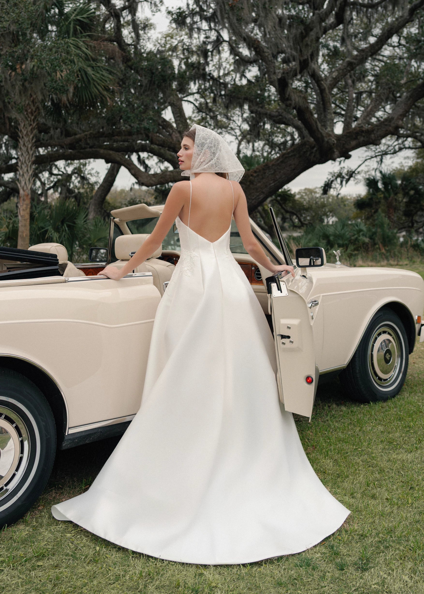 The Charlie gown is a scoopneck spaghetti strap A-line gown of Soft Mikado with Sequined Corded Floral Lattice appliqués in Pearl.