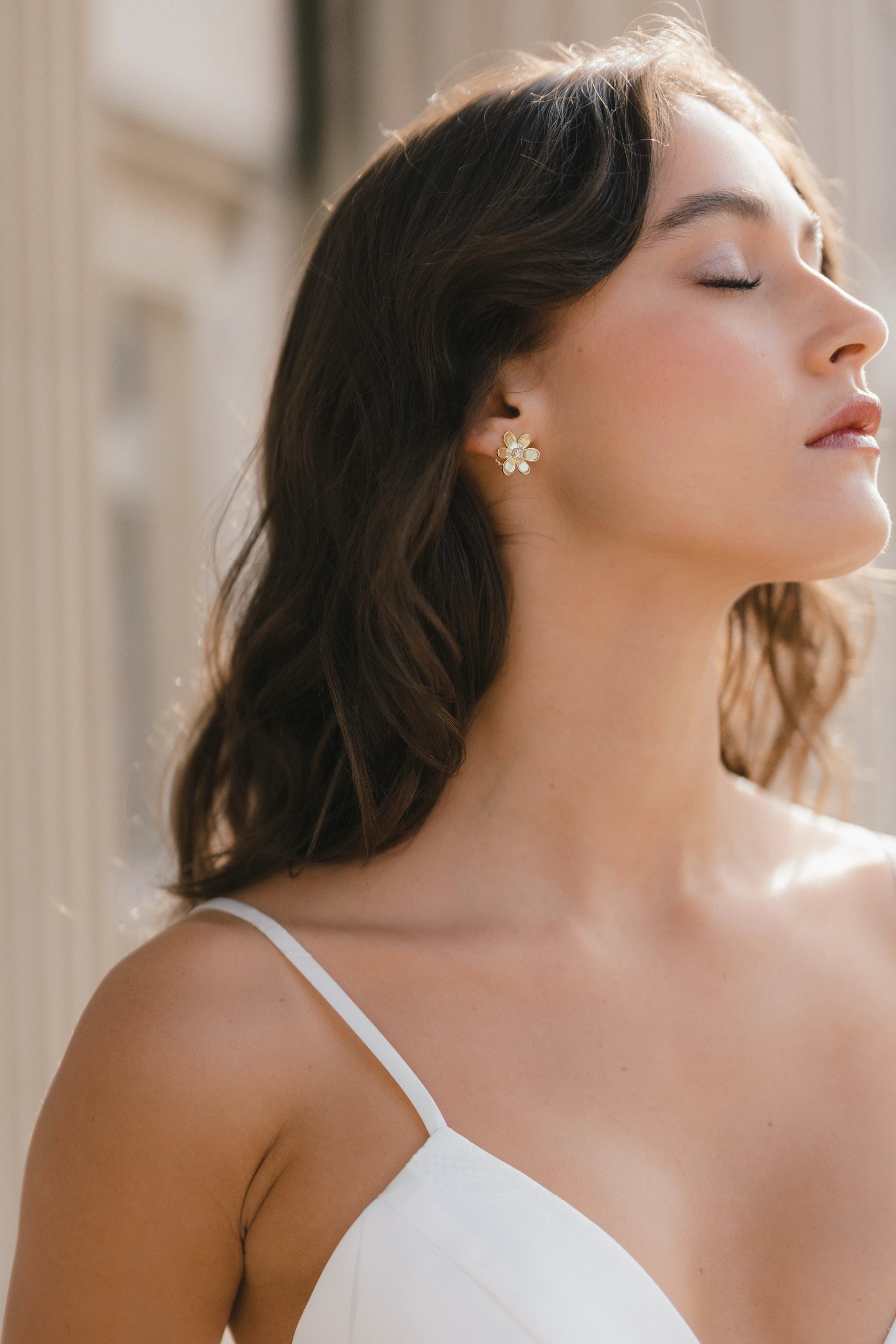 Designed by Atlanta jewelry designer Laura Pearce, delicate Daisy flower studs, featuring a 0.20 CTTW brilliant diamond.