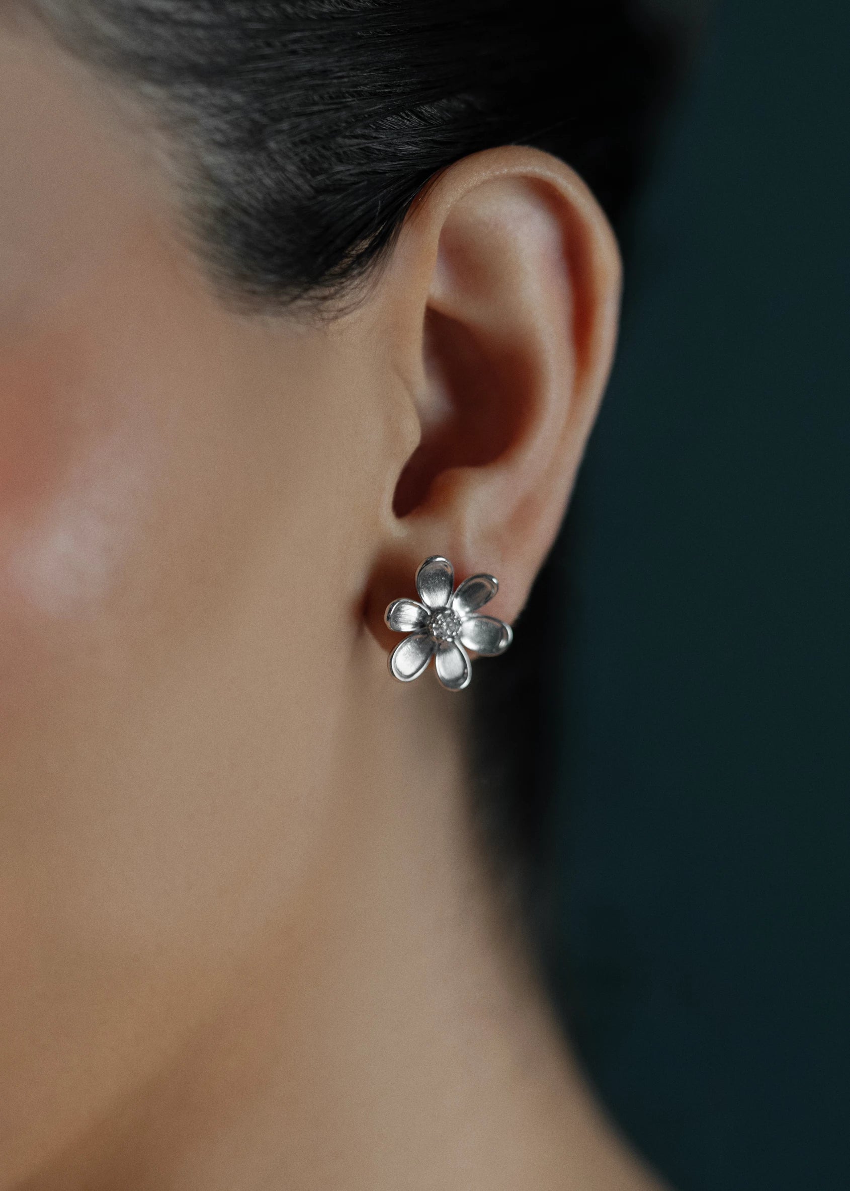 Designed by Atlanta jewelry designer Laura Pearce, delicate Daisy flower studs, featuring a 0.20 CTTW brilliant diamond, and available in 8K Yellow or White Gold.