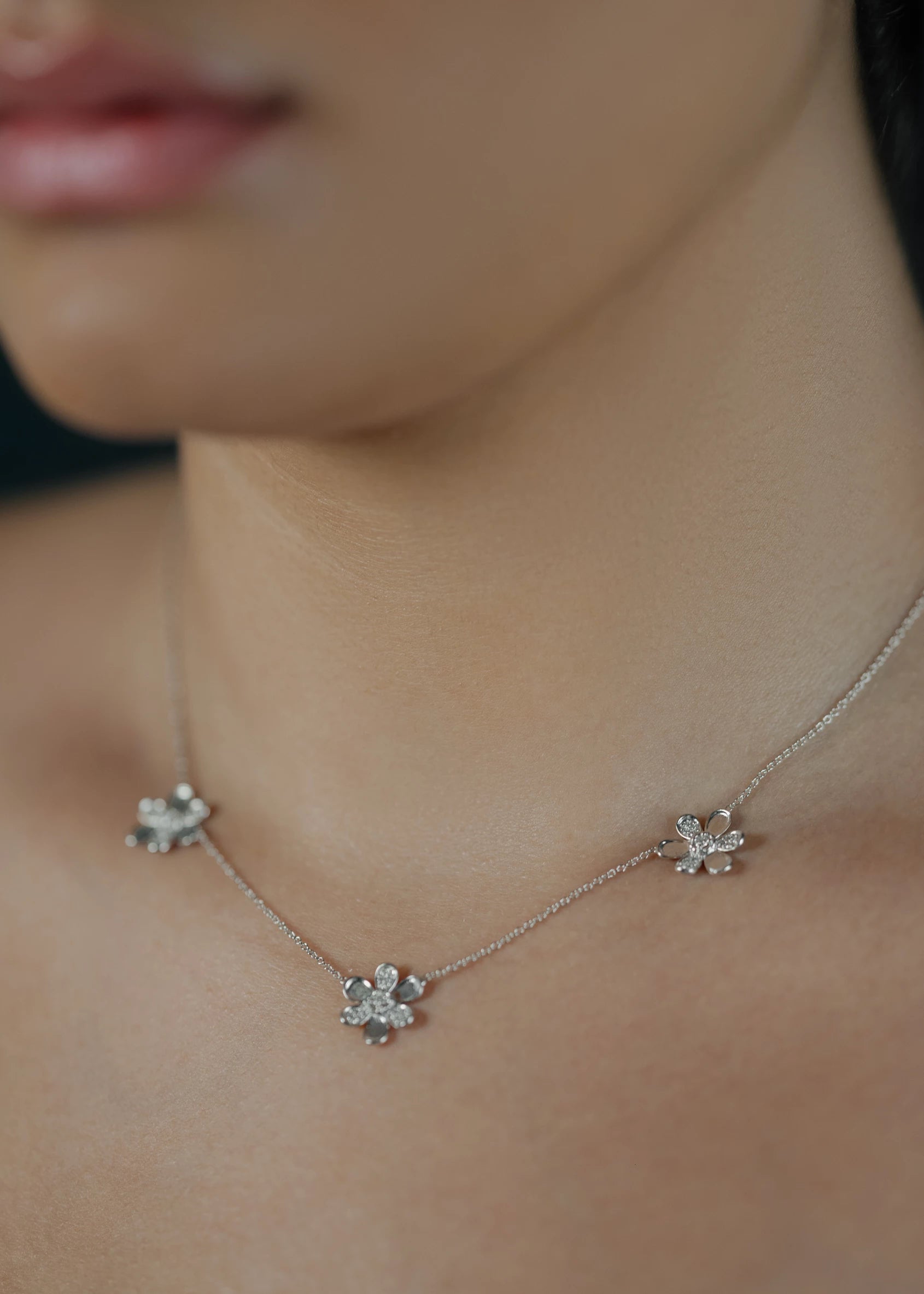 Designed by Atlanta jewelry designer Laura Pearce, three delicate pavé diamond flowers on a 16" strand, featuring 0.27 CTTW of brilliant diamonds and available in 18K Yellow or White Gold.