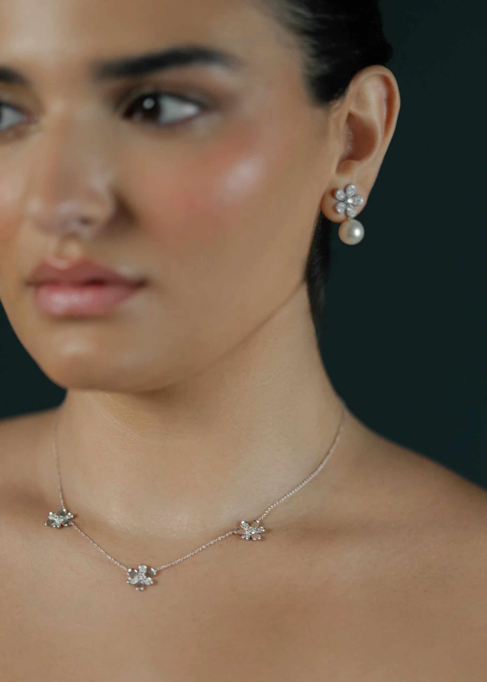 Designed by Atlanta jewelry designer Laura Pearce, three delicate pavé diamond flowers on a 16" strand, featuring 0.27 CTTW of brilliant diamonds and available in 18K Yellow or White Gold.