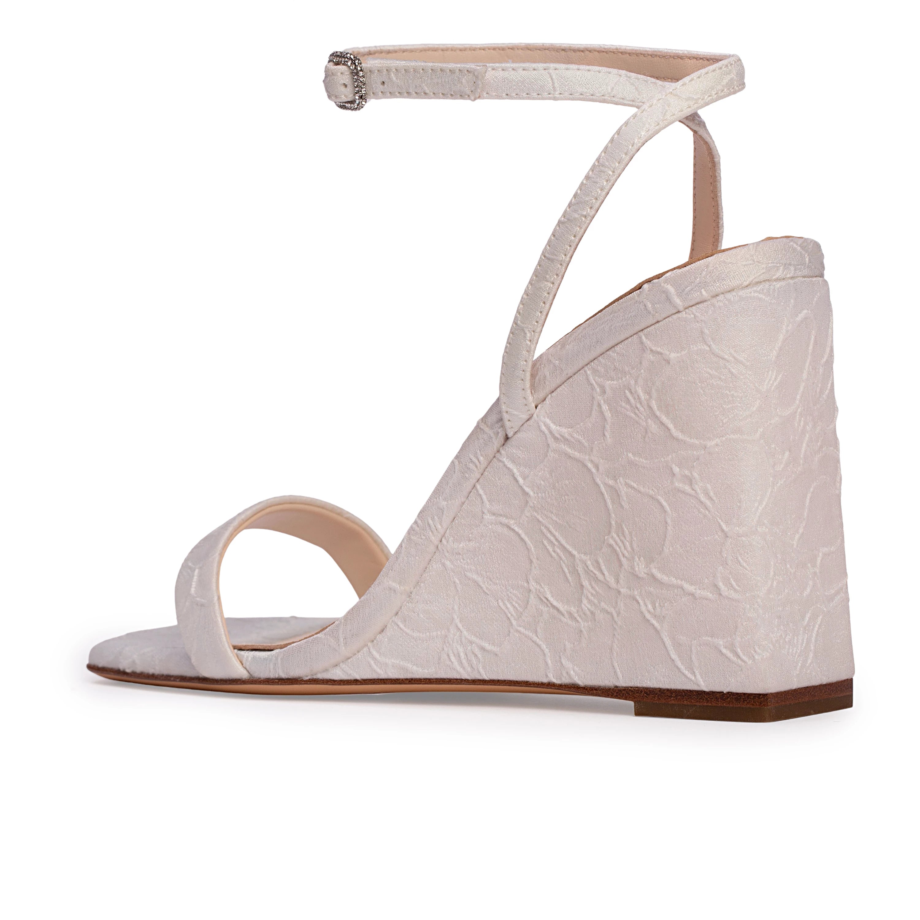 A square-toe wedge sandal set on a classic 95mm heel, featuring a sleek, minimalist upper accented by a square crystal-embellished buckle. Expertly crafted from refined satin jacquard.