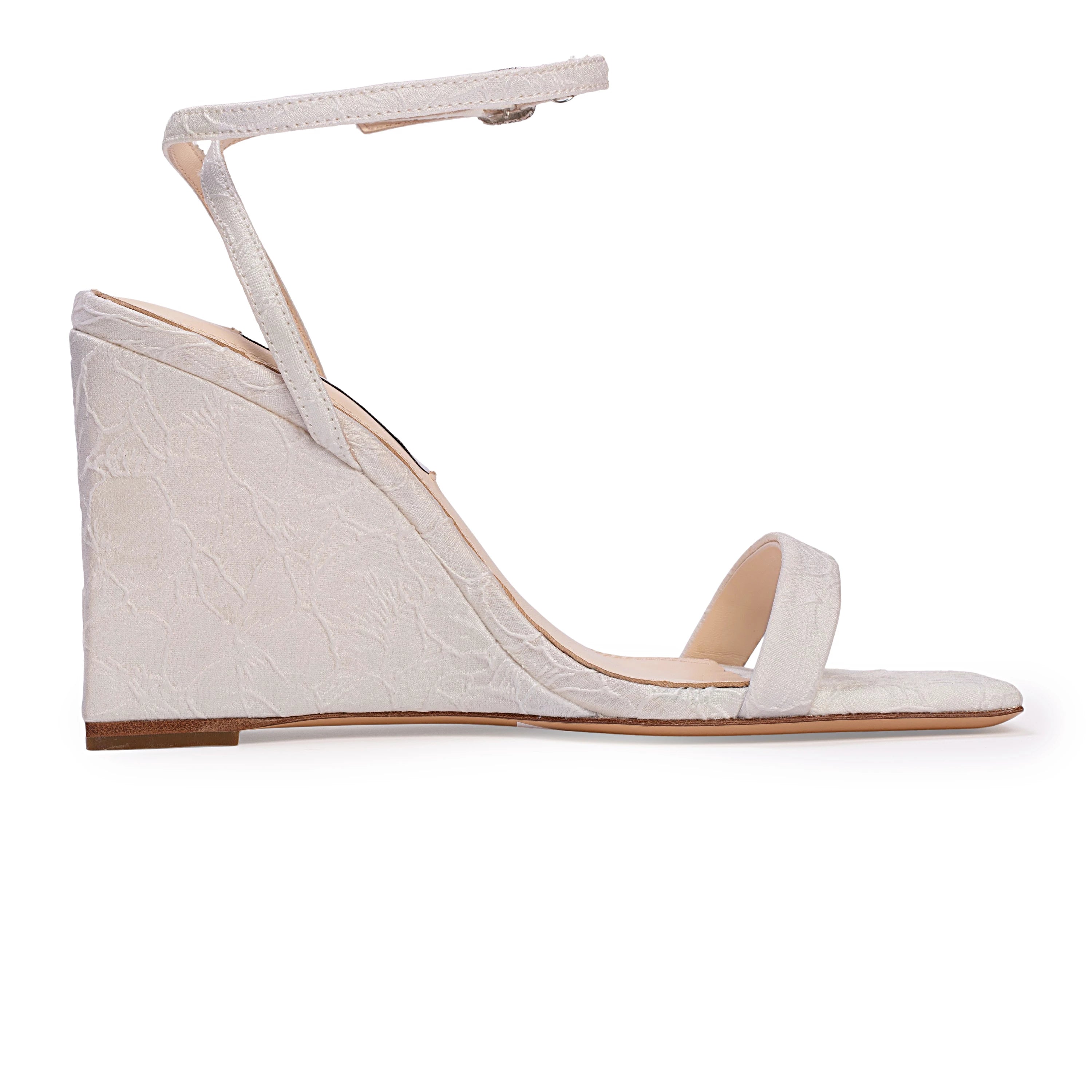 A square-toe wedge sandal set on a classic 95mm heel, featuring a sleek, minimalist upper accented by a square crystal-embellished buckle. Expertly crafted from refined satin jacquard.