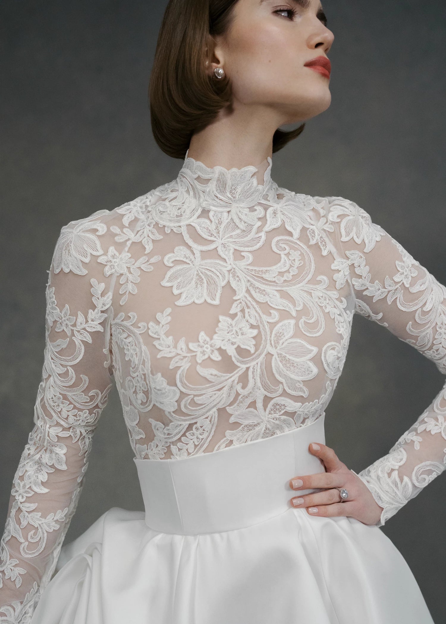 The Gigi Topper by Anne Barge is an Illusion tulle long sleeve mockneck top appliquéd with French Alençon lace in Silk White.