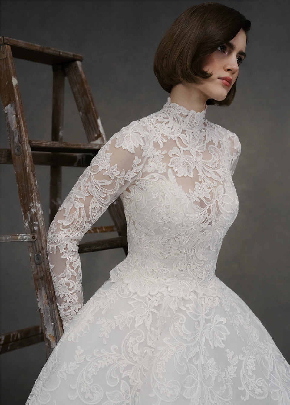 The Gigi Topper by Anne Barge is an Illusion tulle long sleeve mockneck top appliquéd with French Alençon lace in Silk White. 