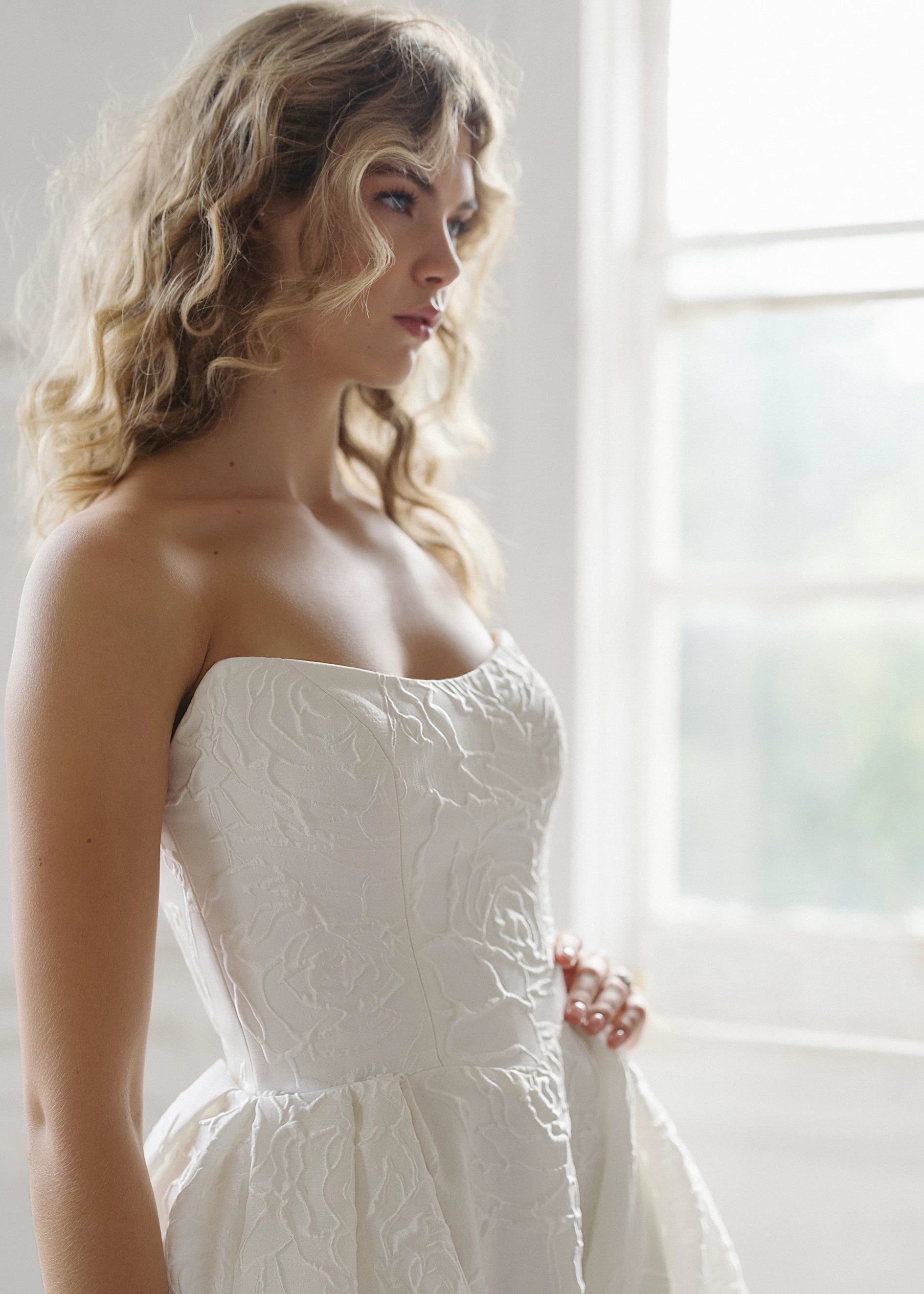 The Heather Train by Anne Barge is a dramatic box pleated detachable train of Rose Embroidered Jacquard with buttons to the hem in Silk White.