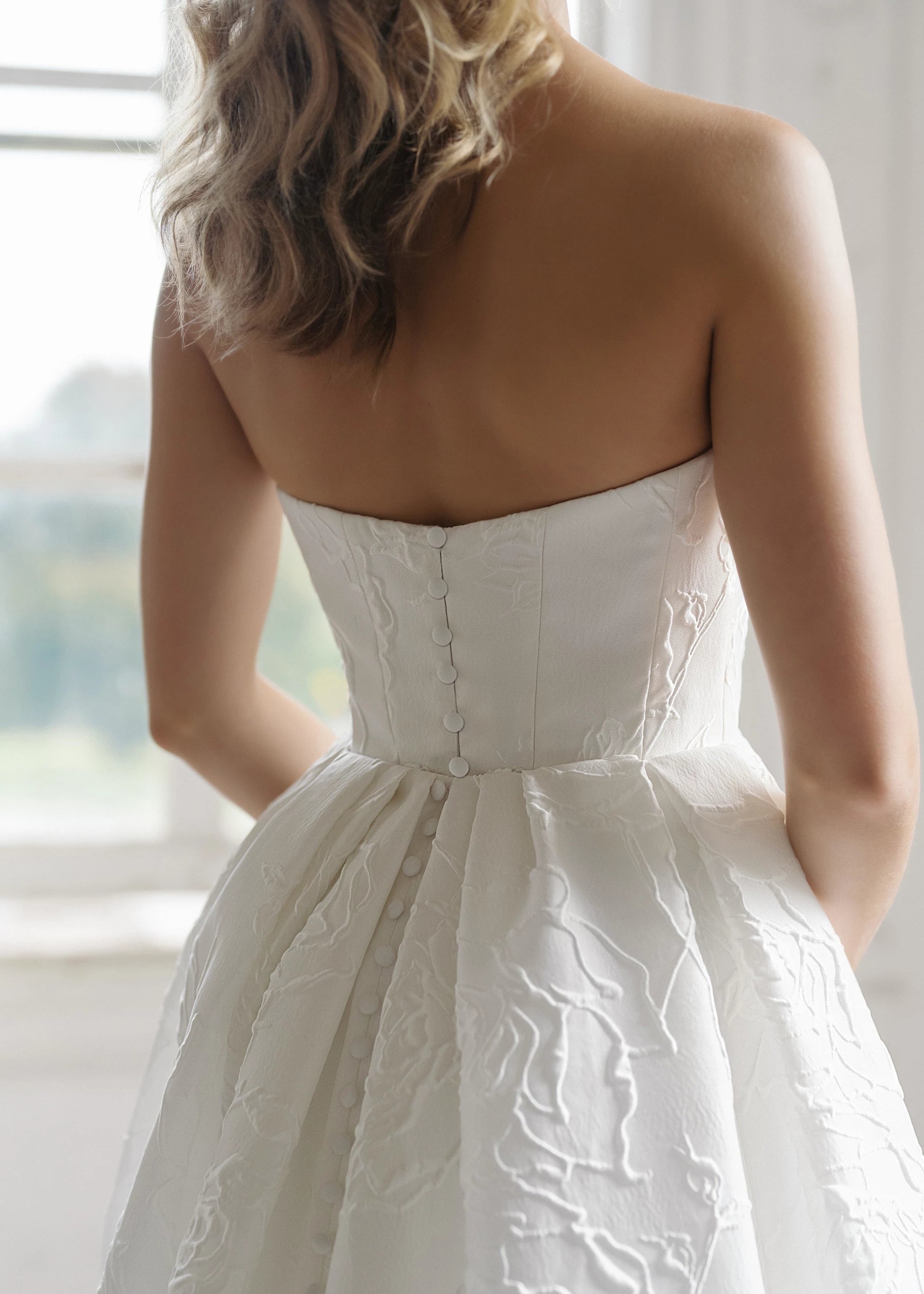 The Heather Train by Anne Barge is a dramatic box pleated detachable train of Rose Embroidered Jacquard with buttons to the hem in Silk White.