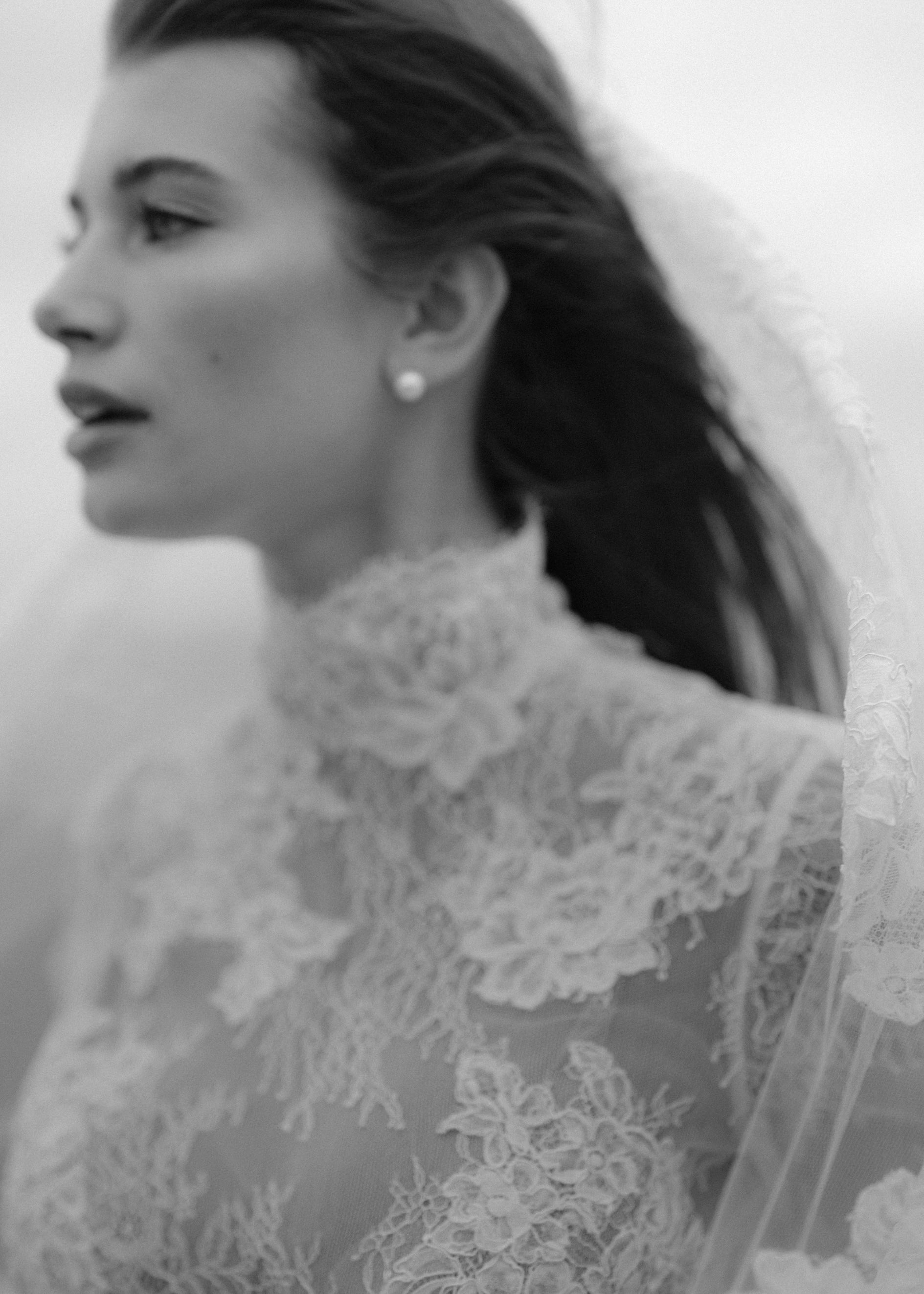 The Leo gown is a mockneck long sleeve columnar gown of Corded Lace gown with Chantilly lace underlay.