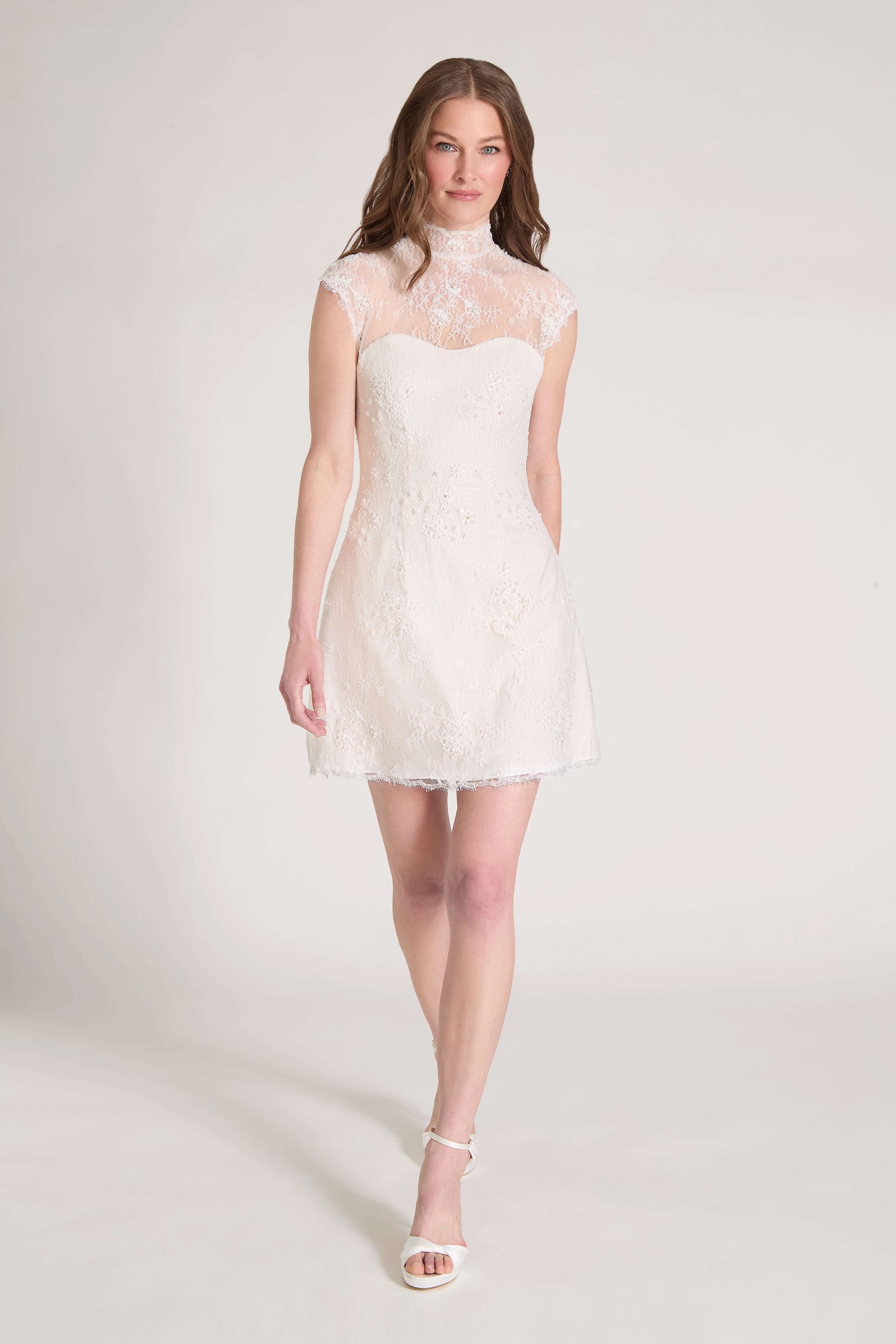 The Blush Crush Little White Dress is a mockneck cap sleeve mini dress of Corded Beaded Chantilly Lace with soft nude tulle underlay in Silk White/Nude.