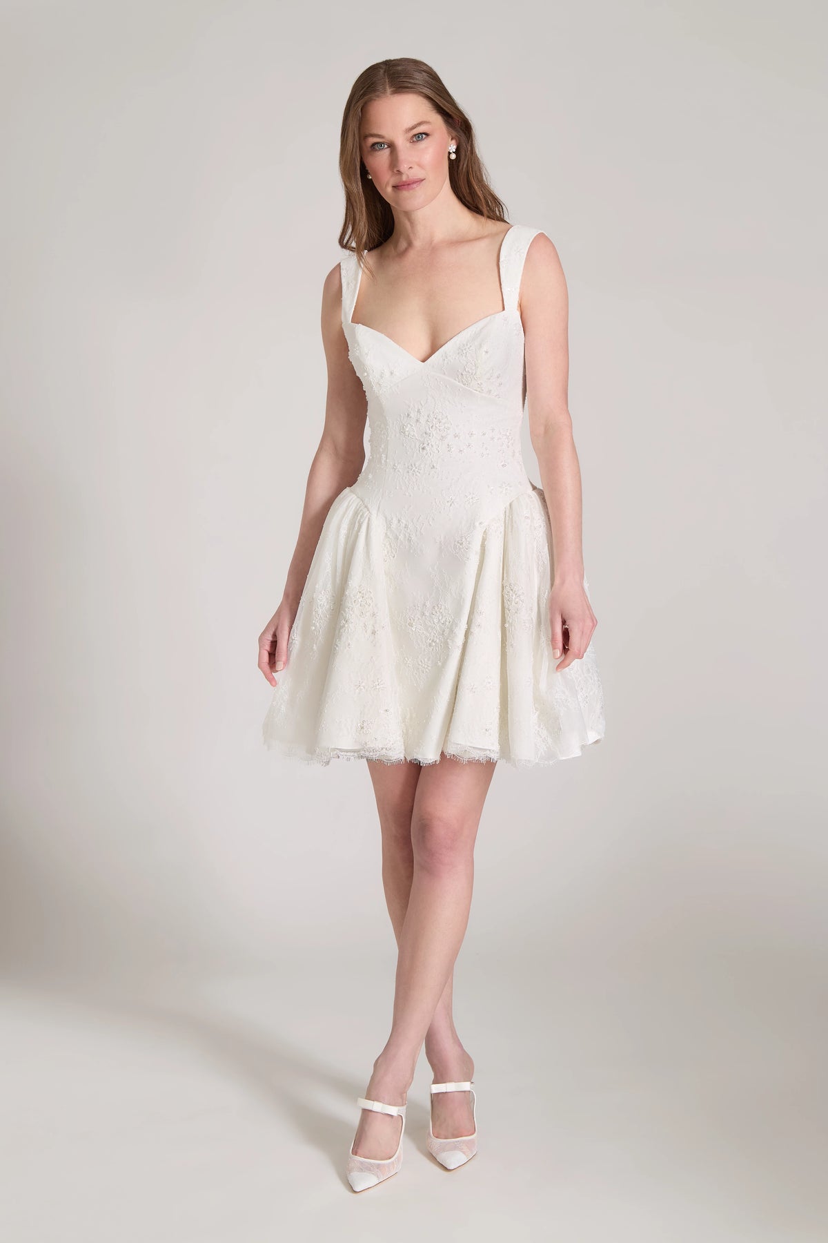 The Lover Little White Dress is a sculpted sweetheart mini dress with contour straps and flirty gathered flounces of Corded Beaded Chantilly Lace in Silk White.