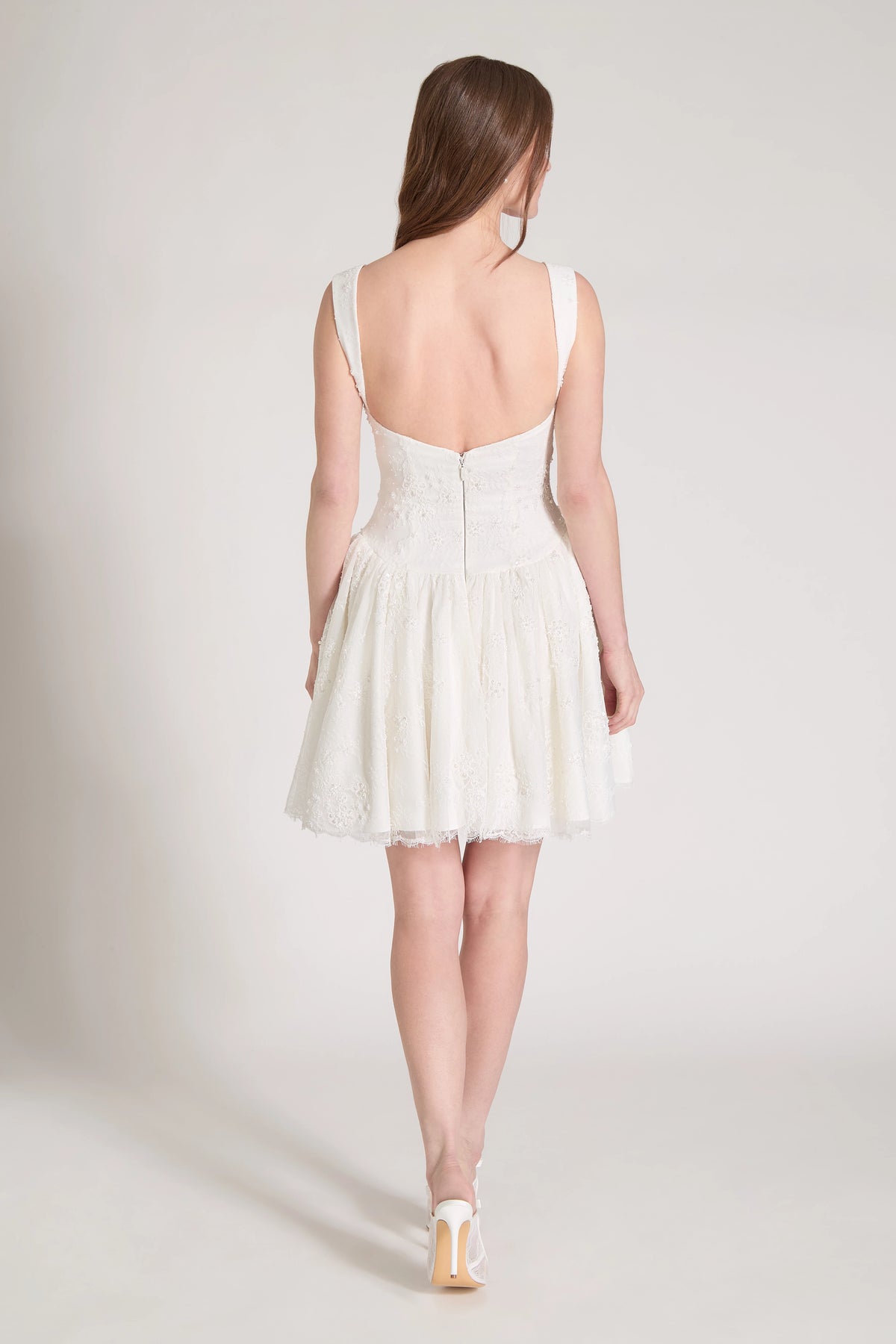 The Lover Little White Dress is a sculpted sweetheart mini dress with contour straps and flirty gathered flounces of Corded Beaded Chantilly Lace in Silk White.