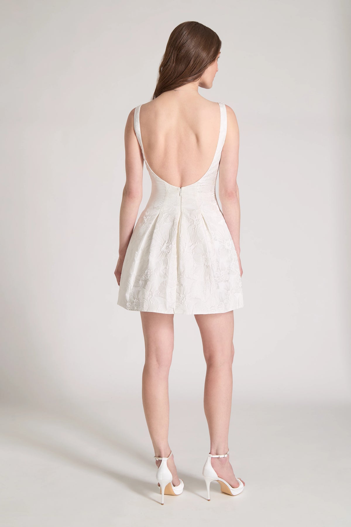 The Petal Pop Little White Dress is a scoop neck mini dress of Hibiscus Jacquard with figure flattering princess seams opening to soft pleats in Silk White.