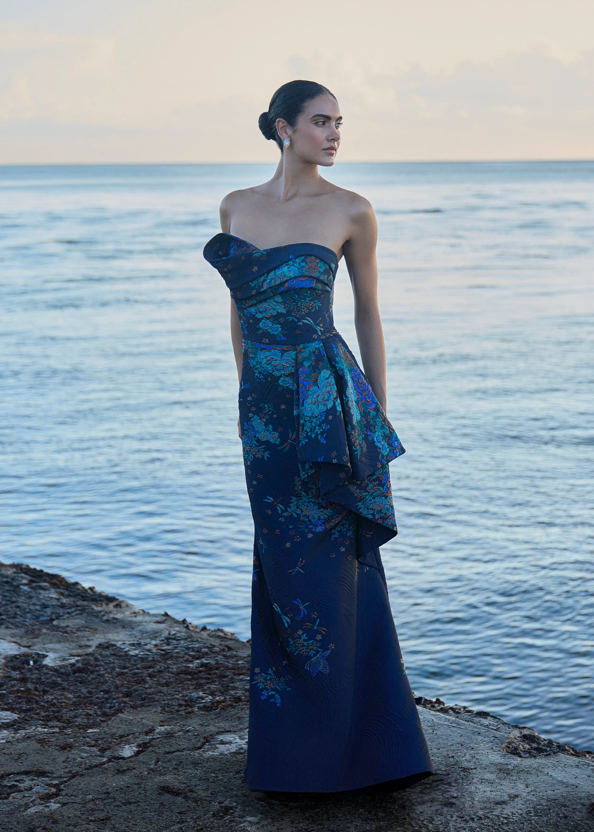 Anne Barge evening gown Mariana, an asymmetrically draped strapless flare gown of Butterfly Blossom Organza Jaquard with side sash. 