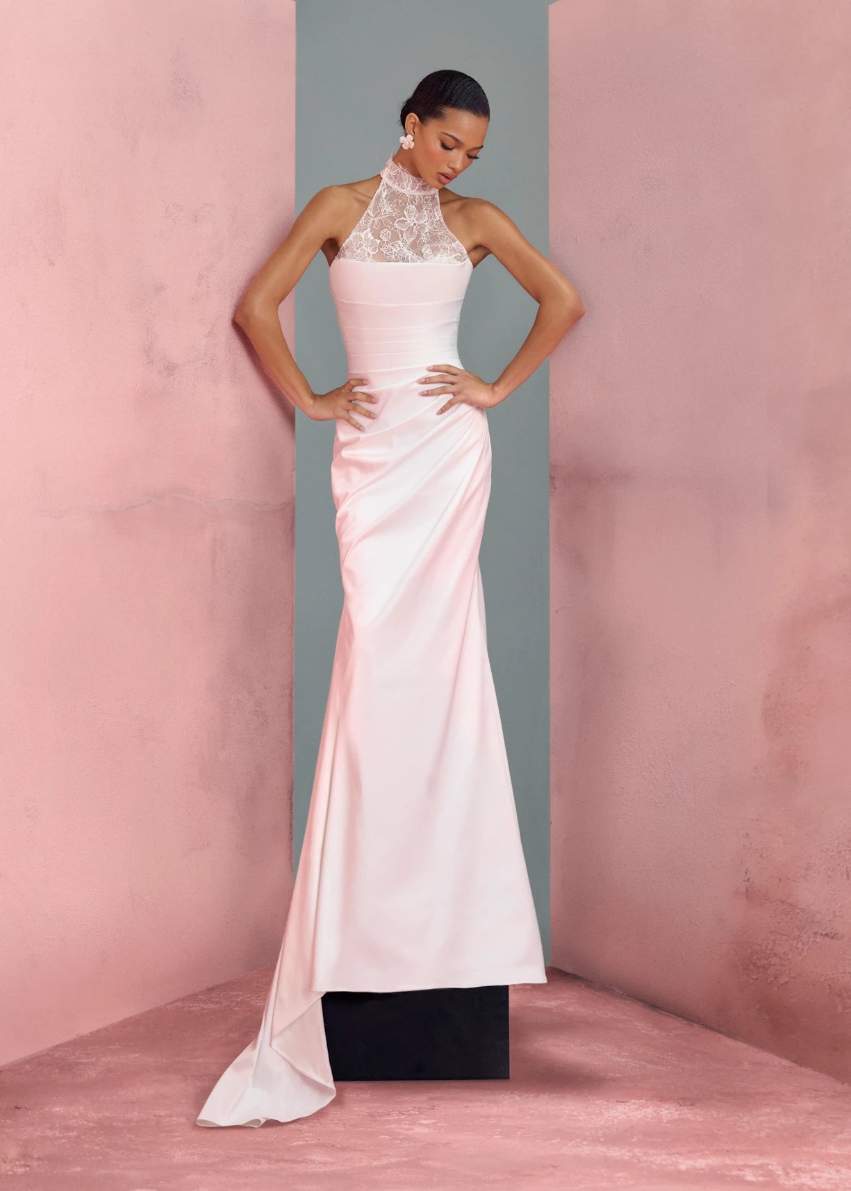 The Marielle gown by Anne Barge is a dramatically draped column gown of Crepe Back Satin featuring a peek-a-boo sweetheart neckline with Petal Beaded Embroidery. Shown with the Marielle Top, a halter neck illusion tulle top of Petal Beaded Embroidery.