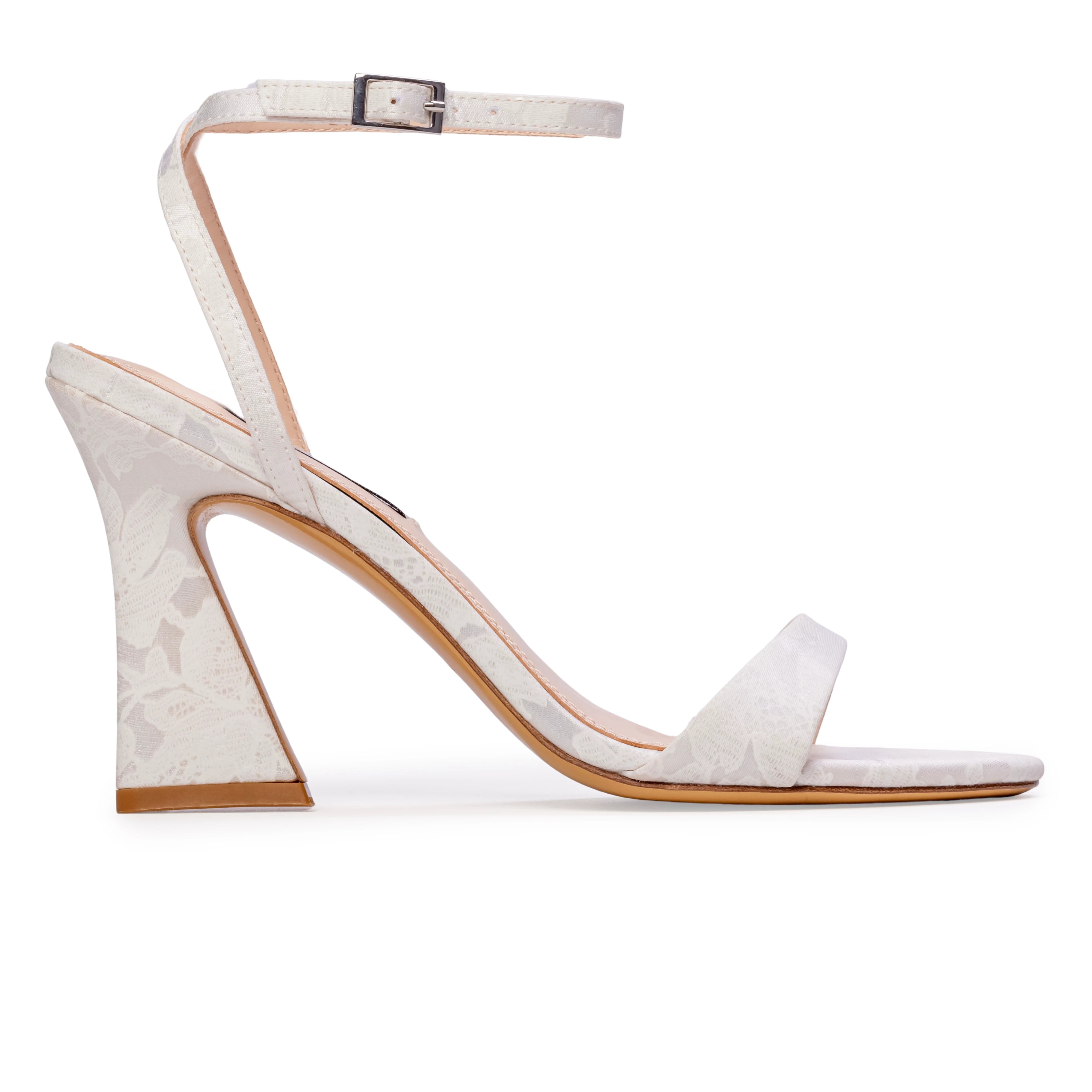 The Anne Barge Muse Floral wedding shoe, is a round toe 90 mm block heel sandal with all over pearl detailing, set on a curved high block heel in White Flower Silk.