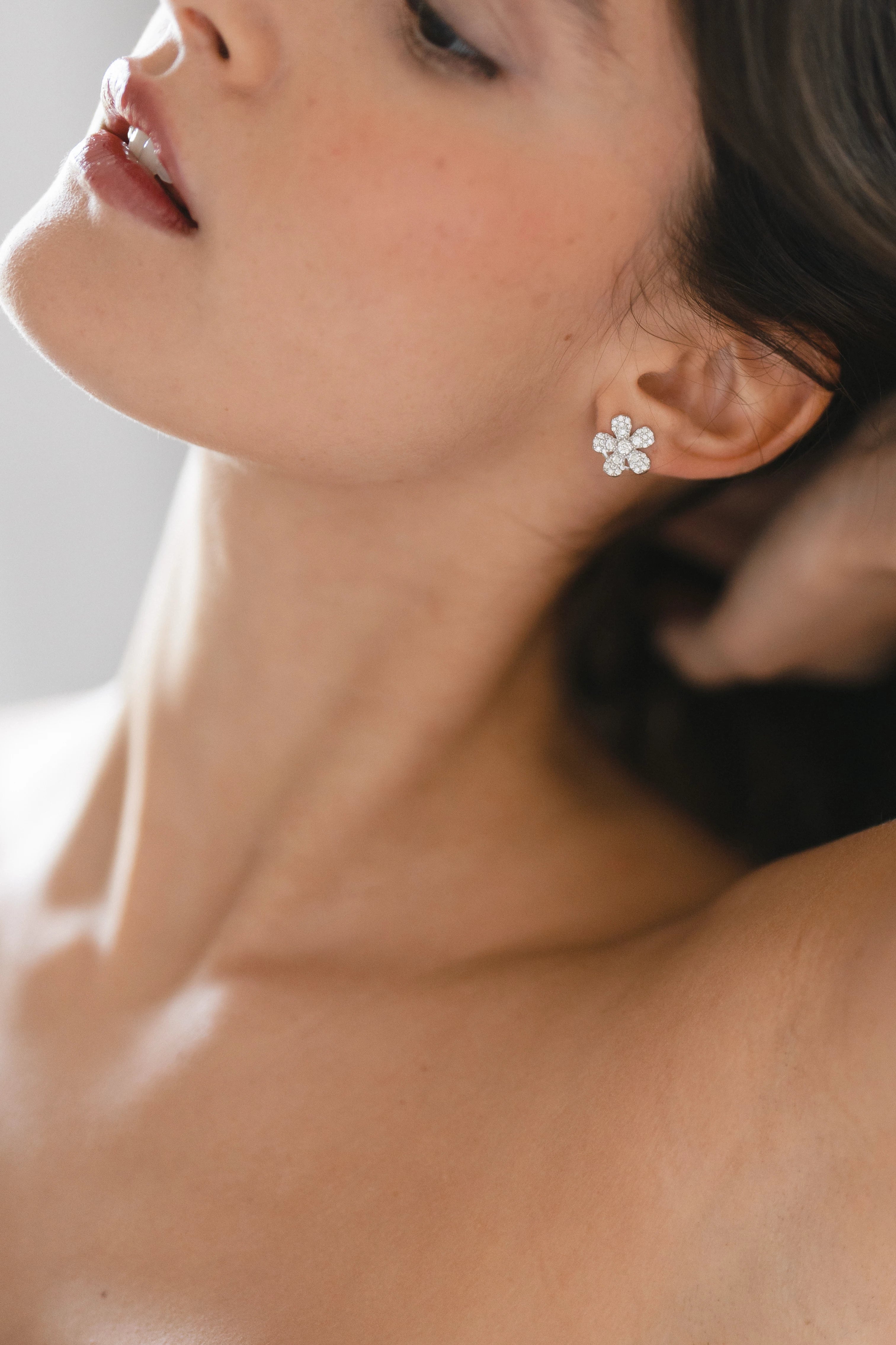 Designed by Atlanta jewelry designer Laura Pearce, delicate pave diamond daisy studs, featuring 0.95 CTTW in brilliant diamonds.
