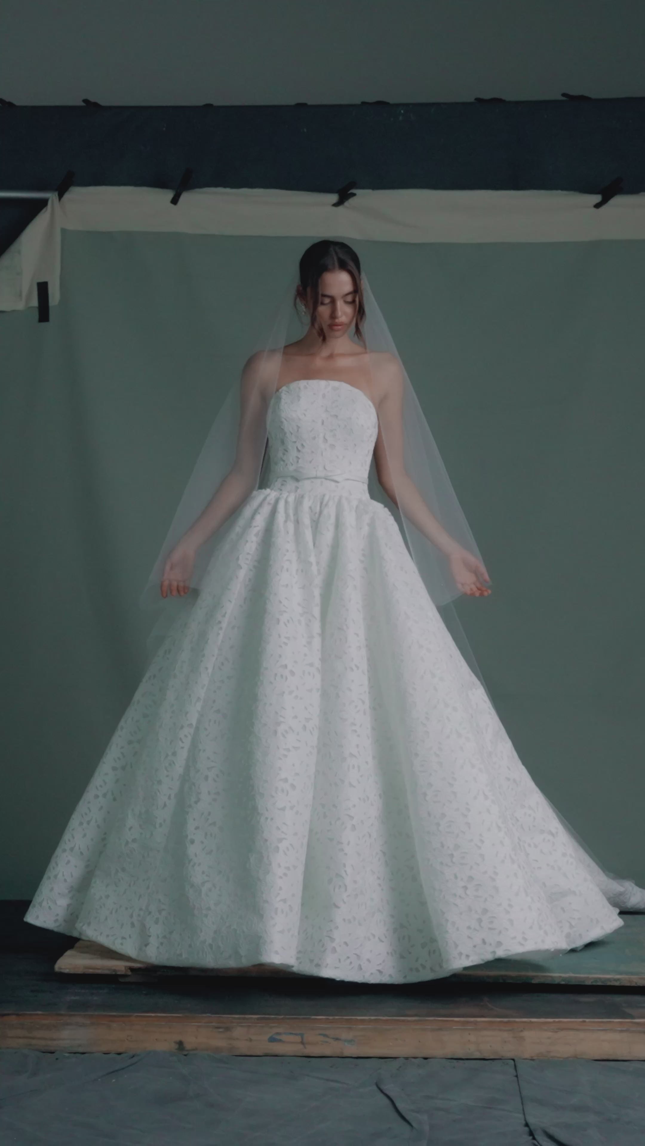 The Charlene gown by Anne Barge is an arched strapless gown in Embroidered Rose Laser Cut Satin with slightly dropped waist and gathered ballgown skirt in Silk White.