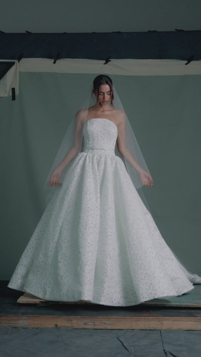 The Charlene gown by Anne Barge is an arched strapless gown in Embroidered Rose Laser Cut Satin with slightly dropped waist and gathered ballgown skirt in Silk White.