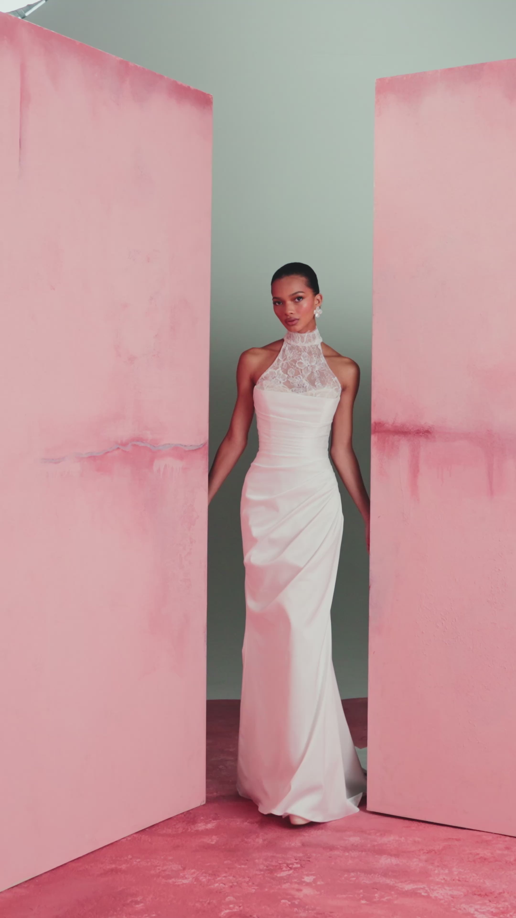 The Marielle gown by Anne Barge is a dramatically draped column gown of Crepe Back Satin featuring a peek-a-boo sweetheart neckline with Petal Beaded Embroidery. Shown with the Marielle Top, a halter neck illusion tulle top of Petal Beaded Embroidery.