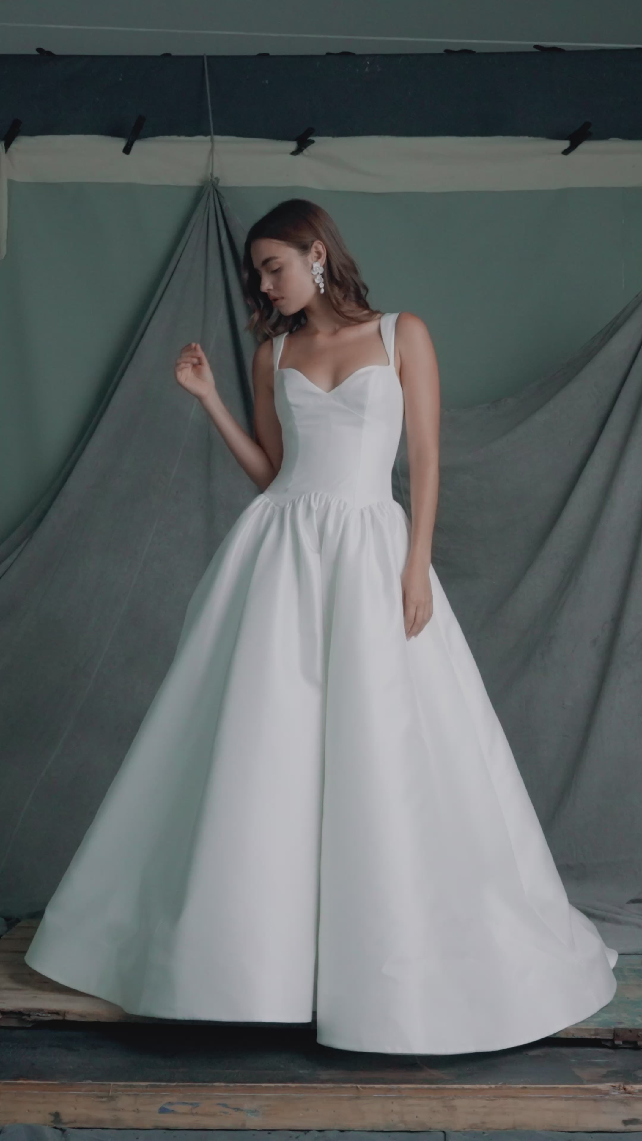 The Verite gown by Anne Barge is a sculpted sweetheart ballgown in Kalika with contour straps, featuring a ziggurat dropped waist and buttons to the hem. 