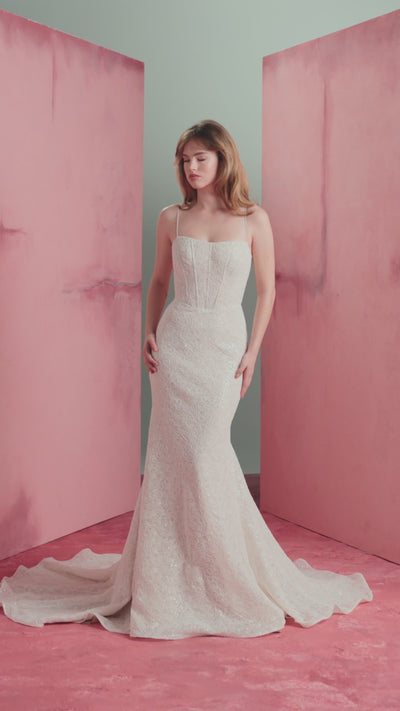 The Delia gown by Anne Barge is a spaghetti strap contour neckline gown with molded corset and softly flared skirt, in sequined corded embroidery over Chantilly lace in Silk White / Nude.