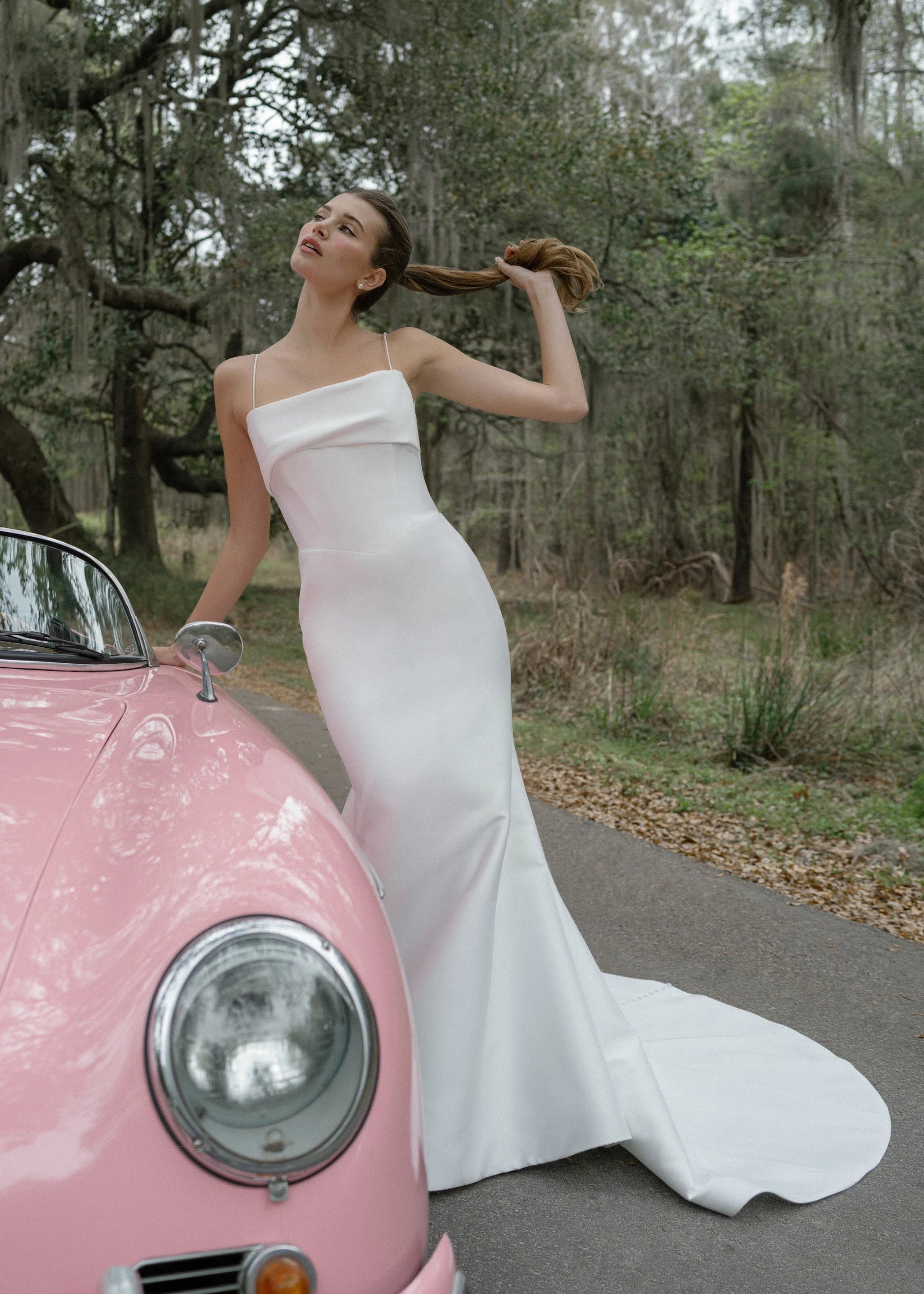 The Radcliffe gown is a spaghetti strap fit and flare gown of Soft Mikado with sculpted bodice, asymmetric bodice draping and buttons to the hem.