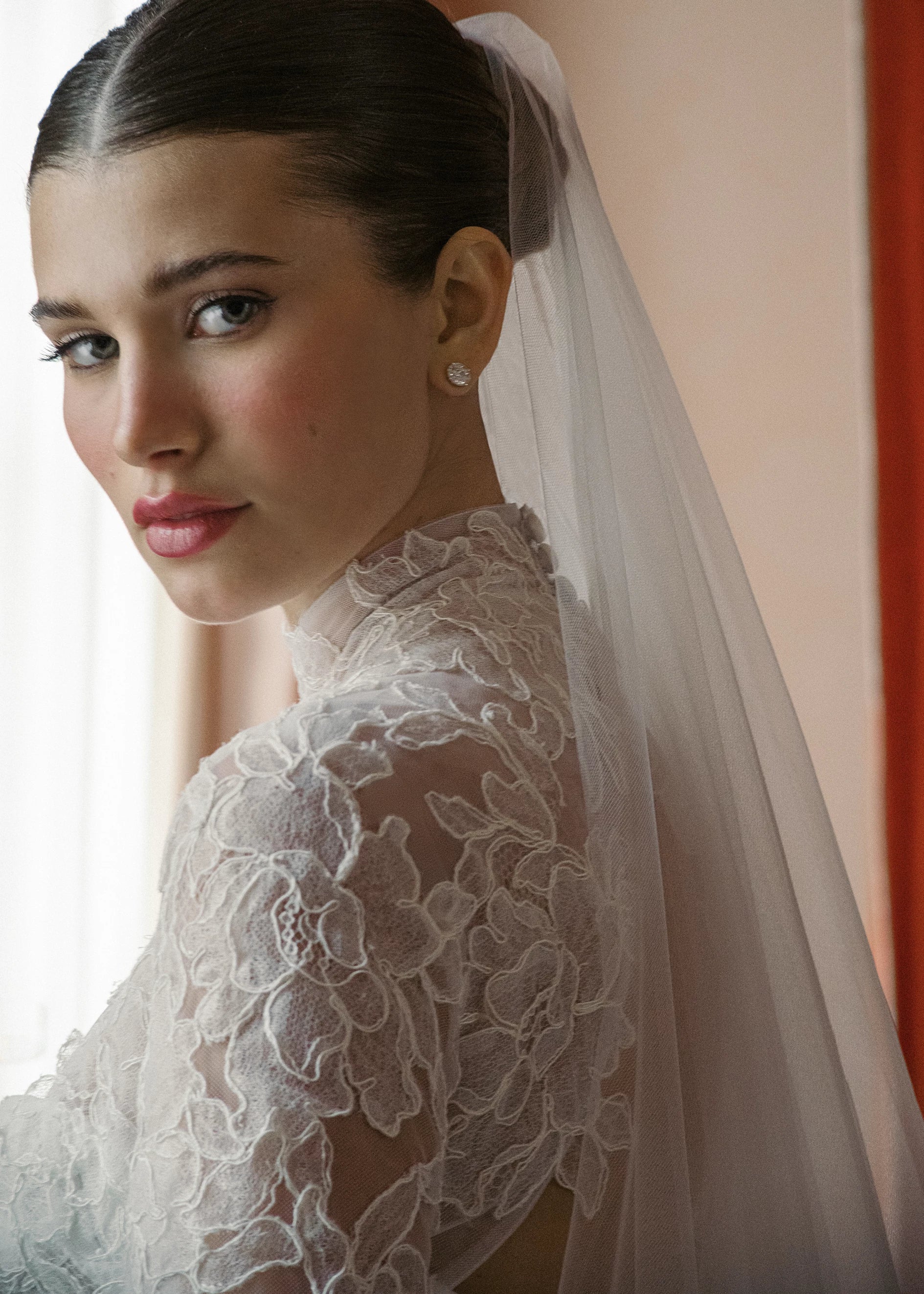 The Sully Topper by Anne Barge is a keyhole illusion tulle topper with mockneck featuring Alencon Lace appliques in Silk White.