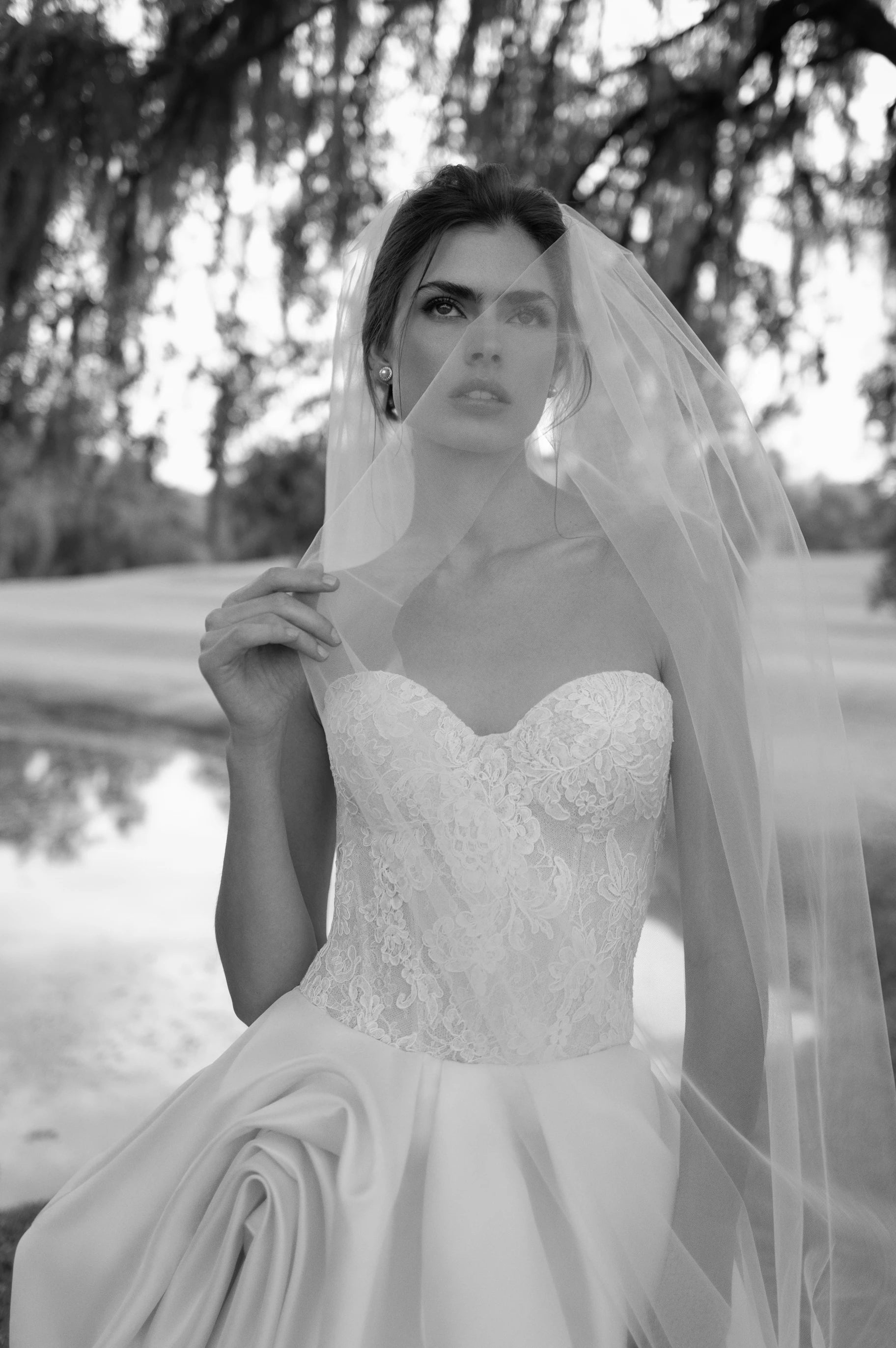 The Wentworth gown is a strapless drop waist corset bodice of French Alençon and Chantilly laces with an Italian Kalika ballgown skirt featuring sculptural origami-style pick-ups and asymmetric waterfall draping.